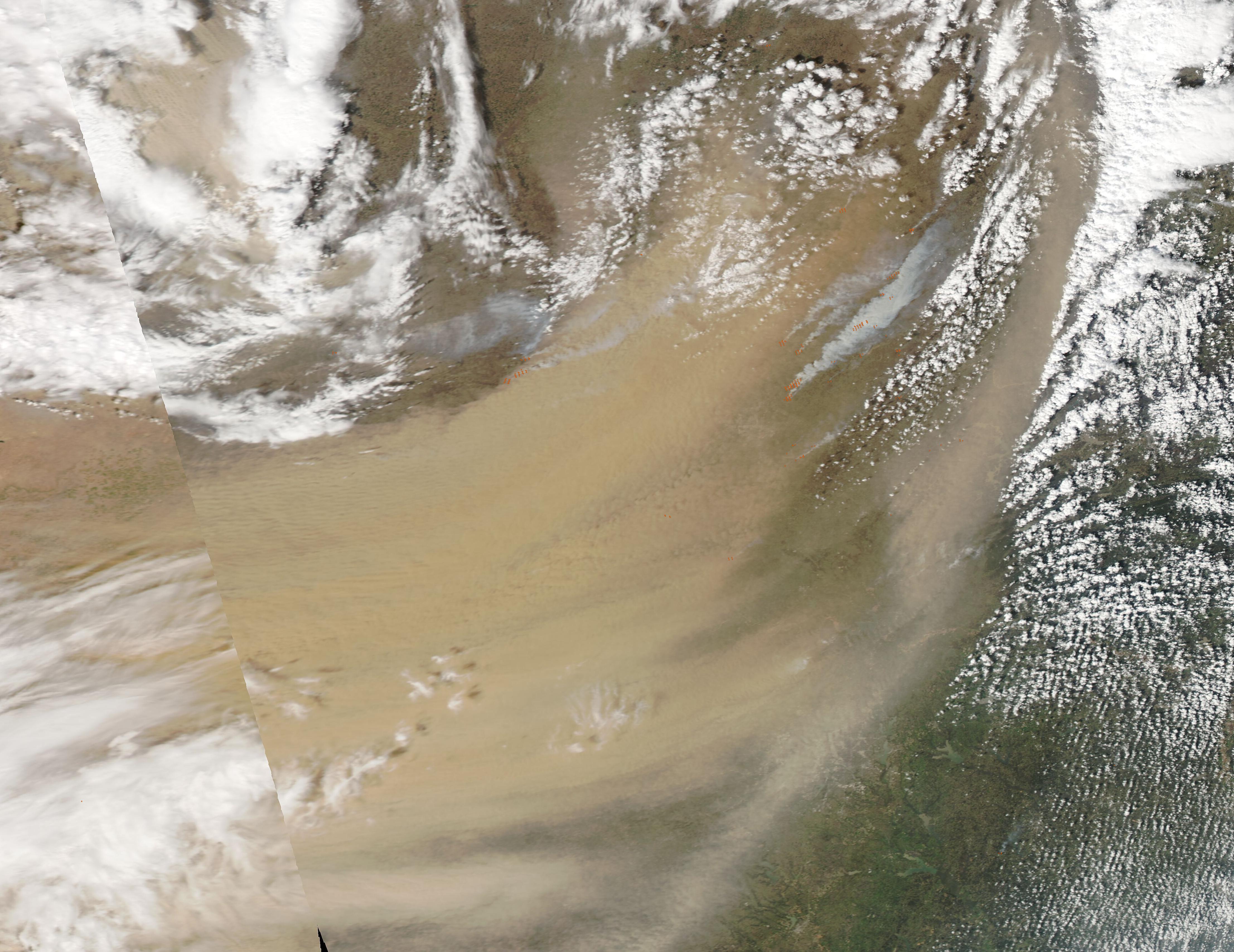 Satellite view of a large dust storm and smoke plumes over Texas and Oklahoma.