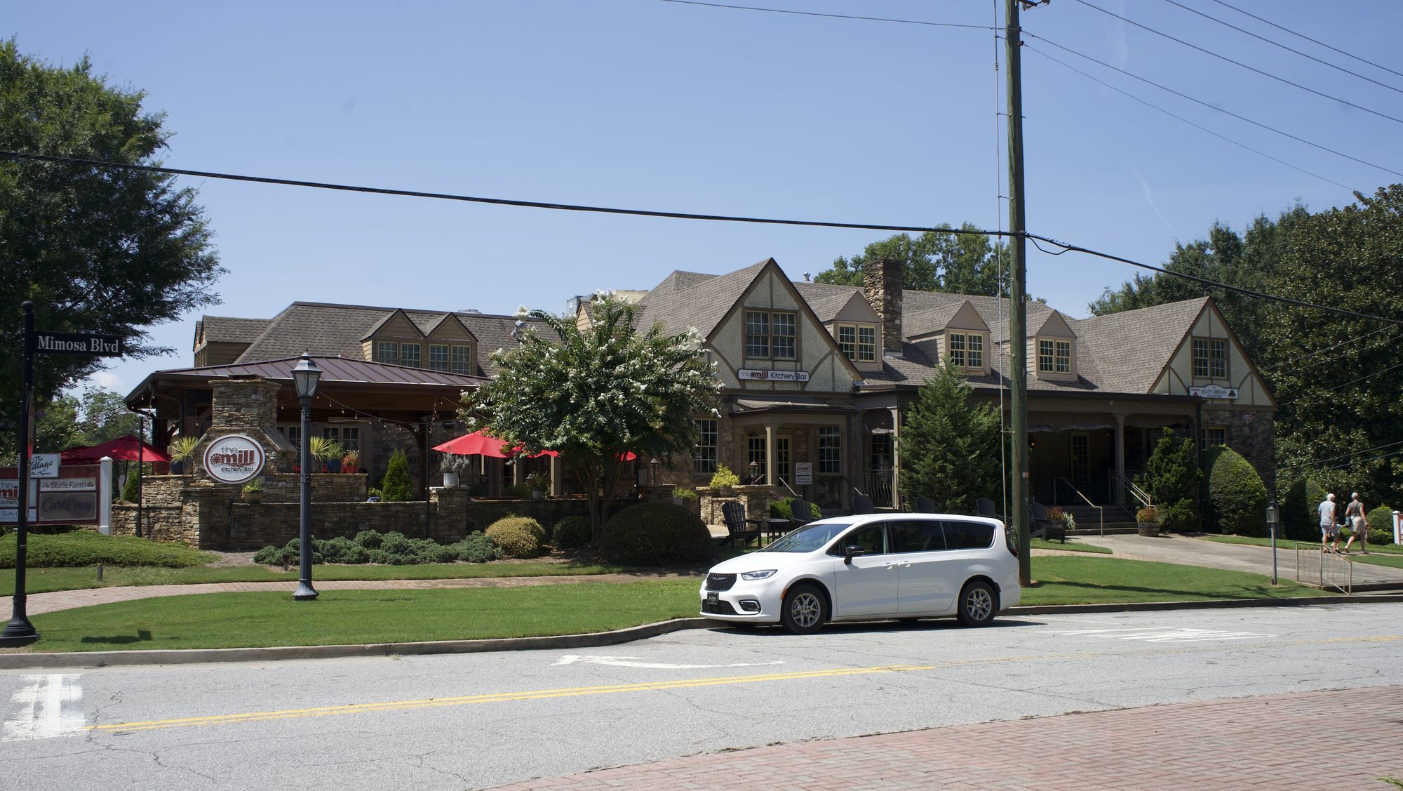 Tudor-style commercial building on a brick-paved downtown street corner.