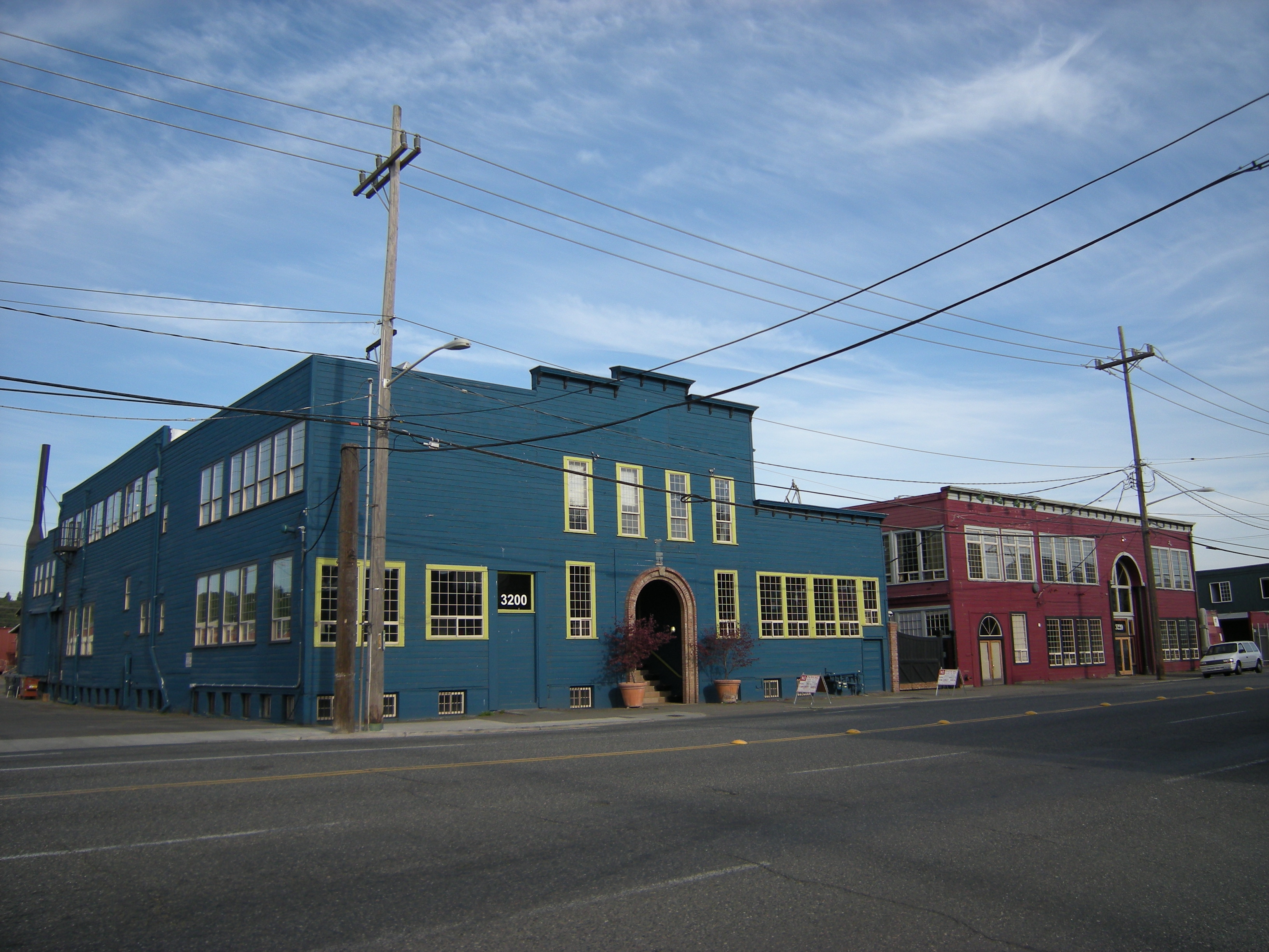 Blue and red brick industrial buildings lining First Avenue South in SODO, Seattle.