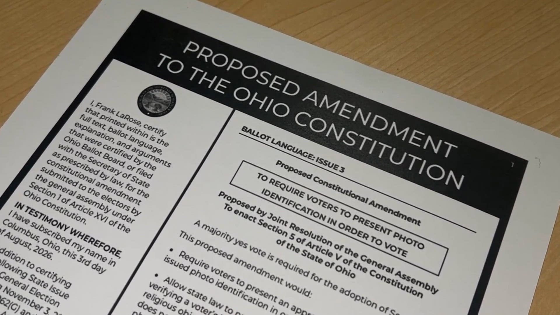Printed document titled Proposed Amendment to the Ohio Constitution on a wooden surface.