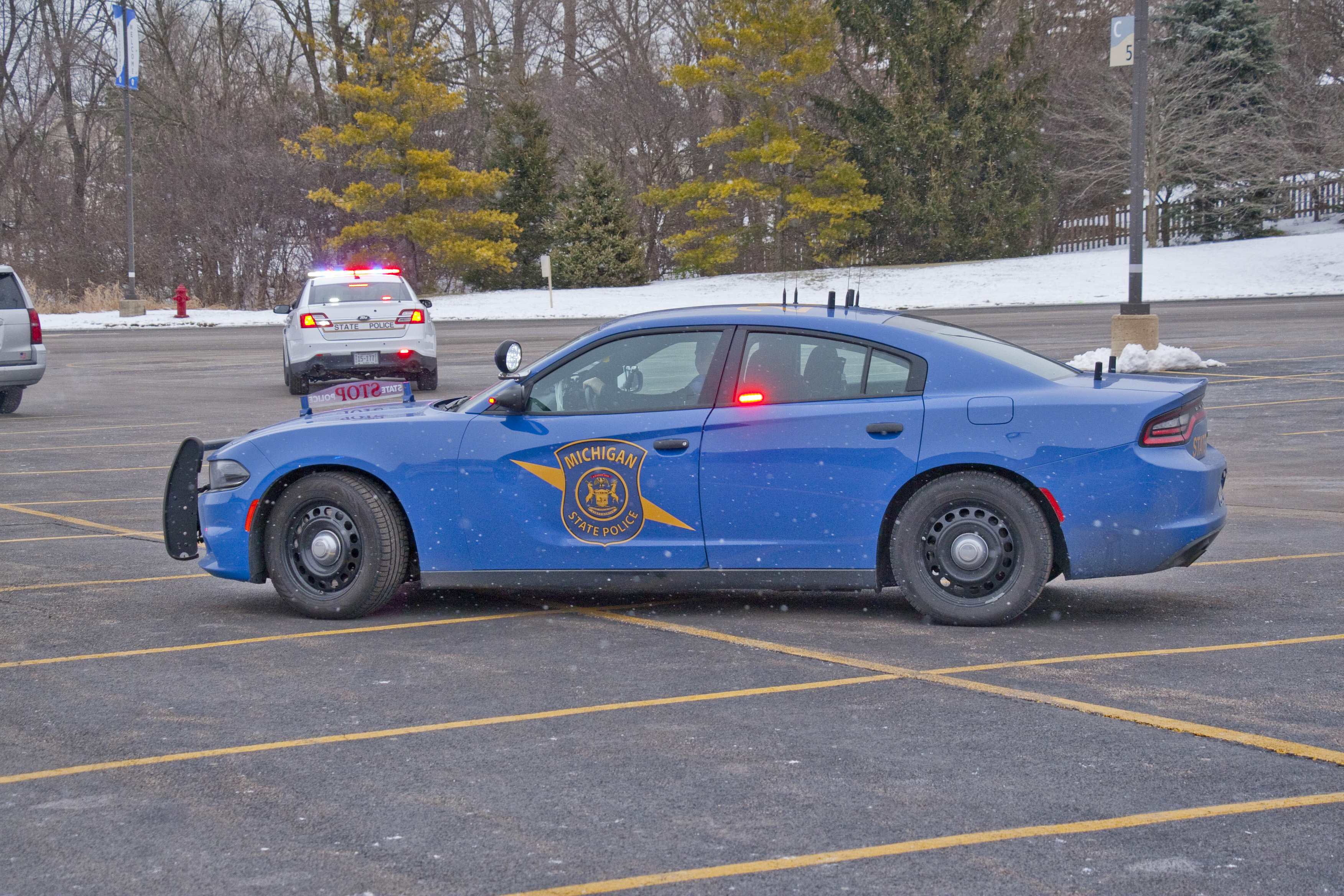 A Michigan State Police patrol car parked in a snowy lot.