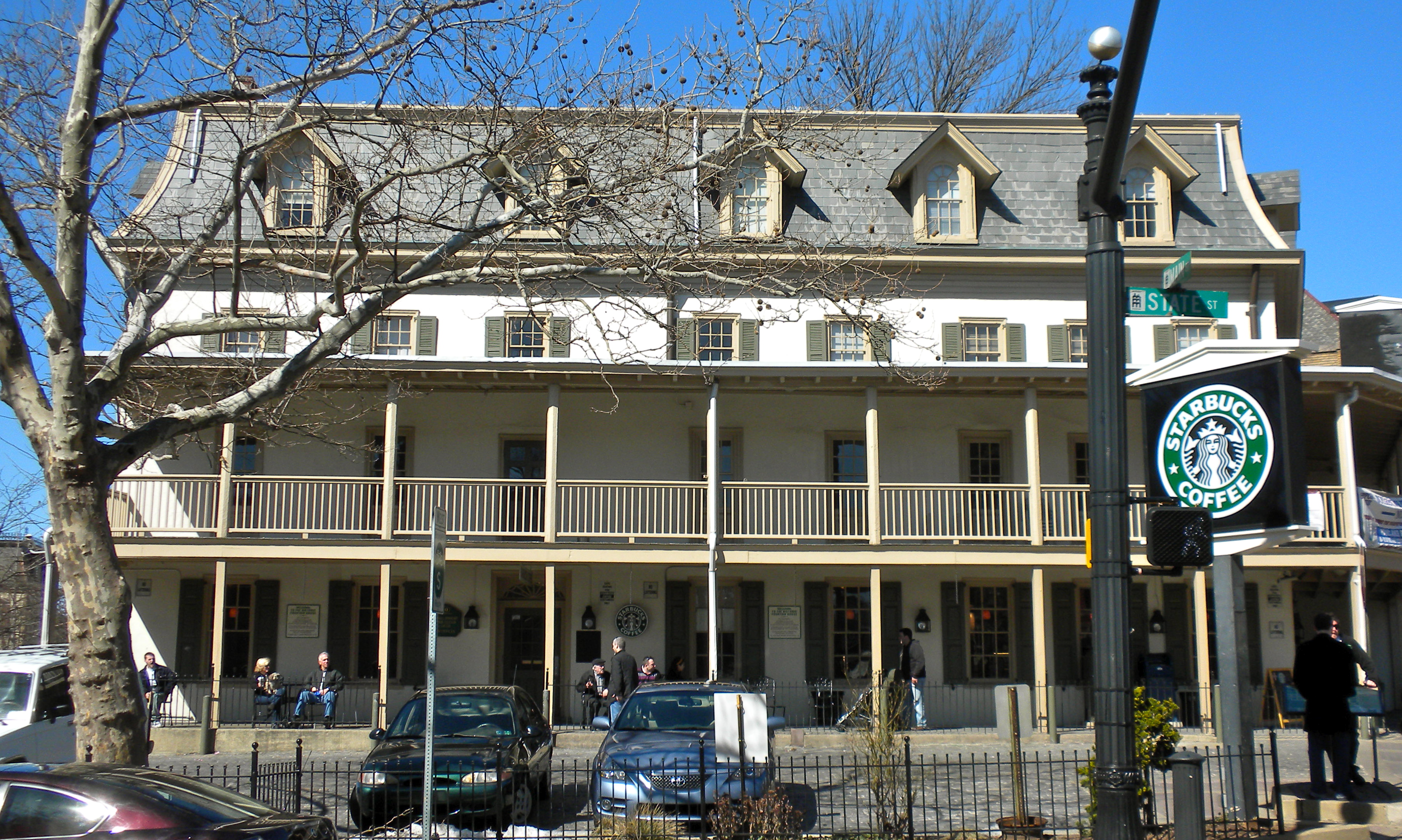 Historic multi-story building with mansard roof at a Doylestown street corner.