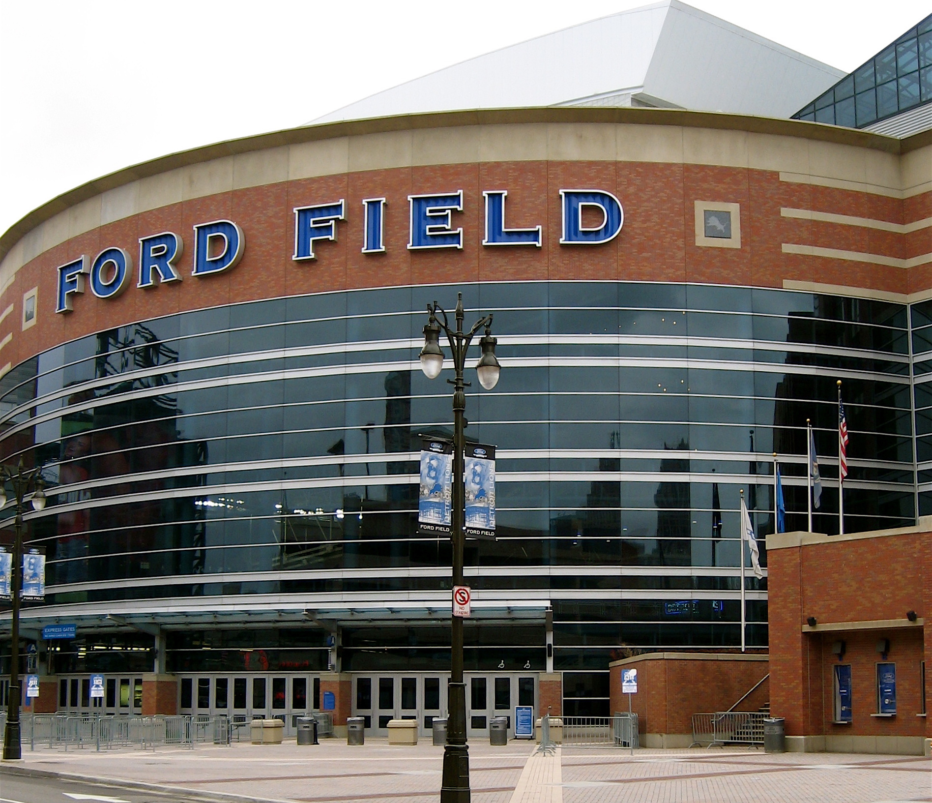 Exterior of Ford Field stadium with large blue lettering and a street lamp in the foreground.
