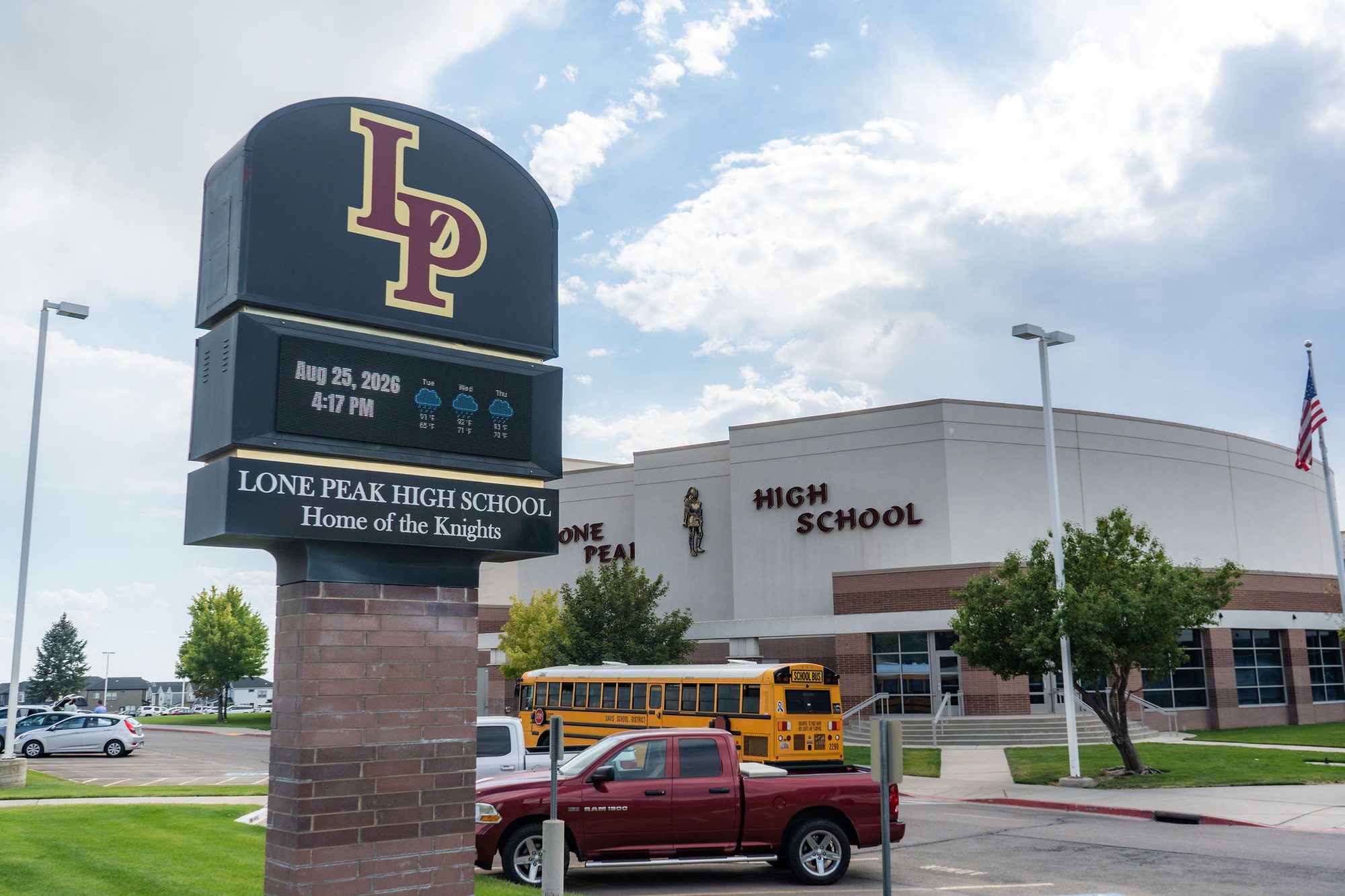 Exterior of a high school building with a monument sign reading Home of the Knights.
