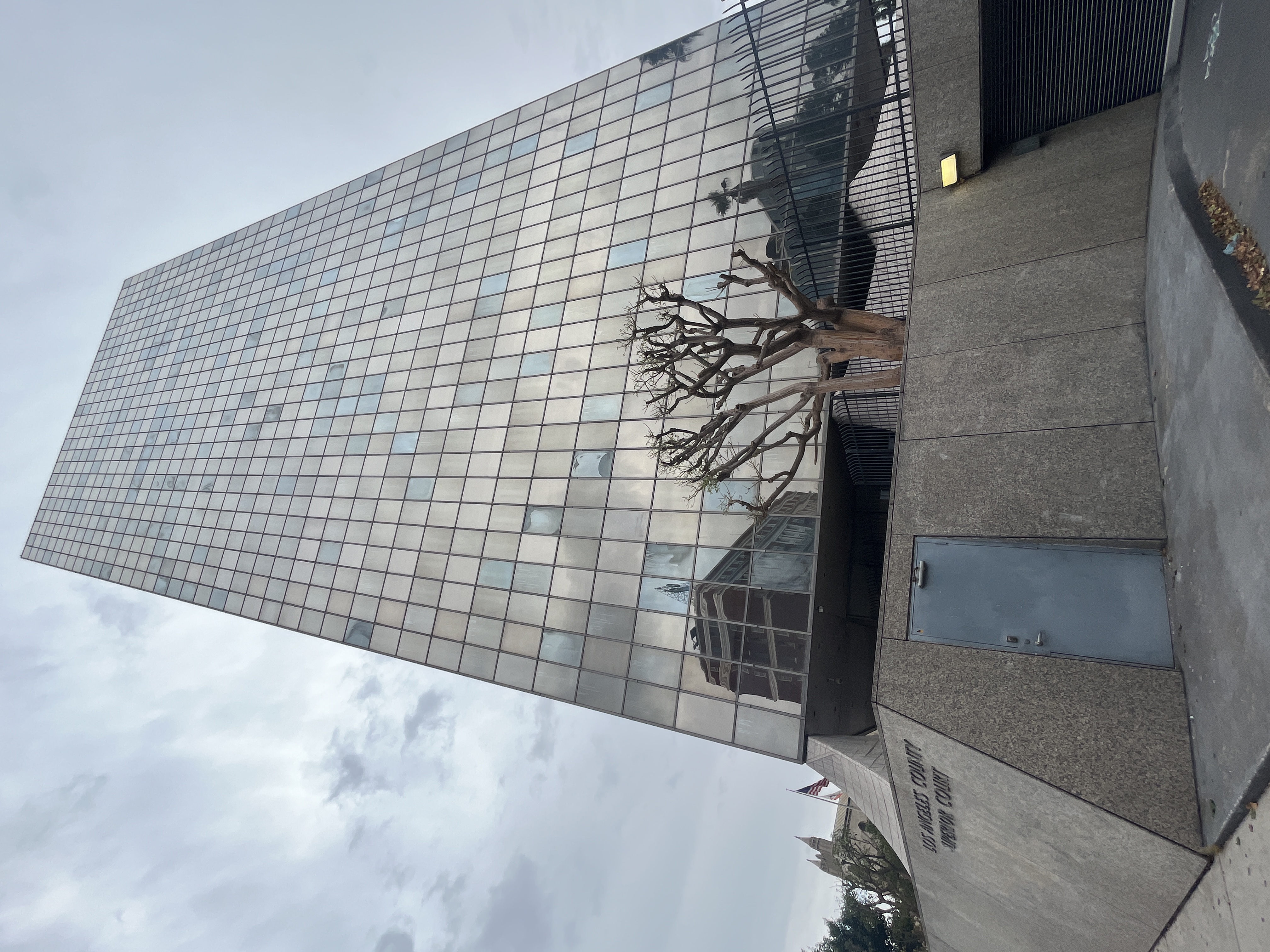 Glass skyscraper with Los Angeles County Superior Court signage on its concrete base.