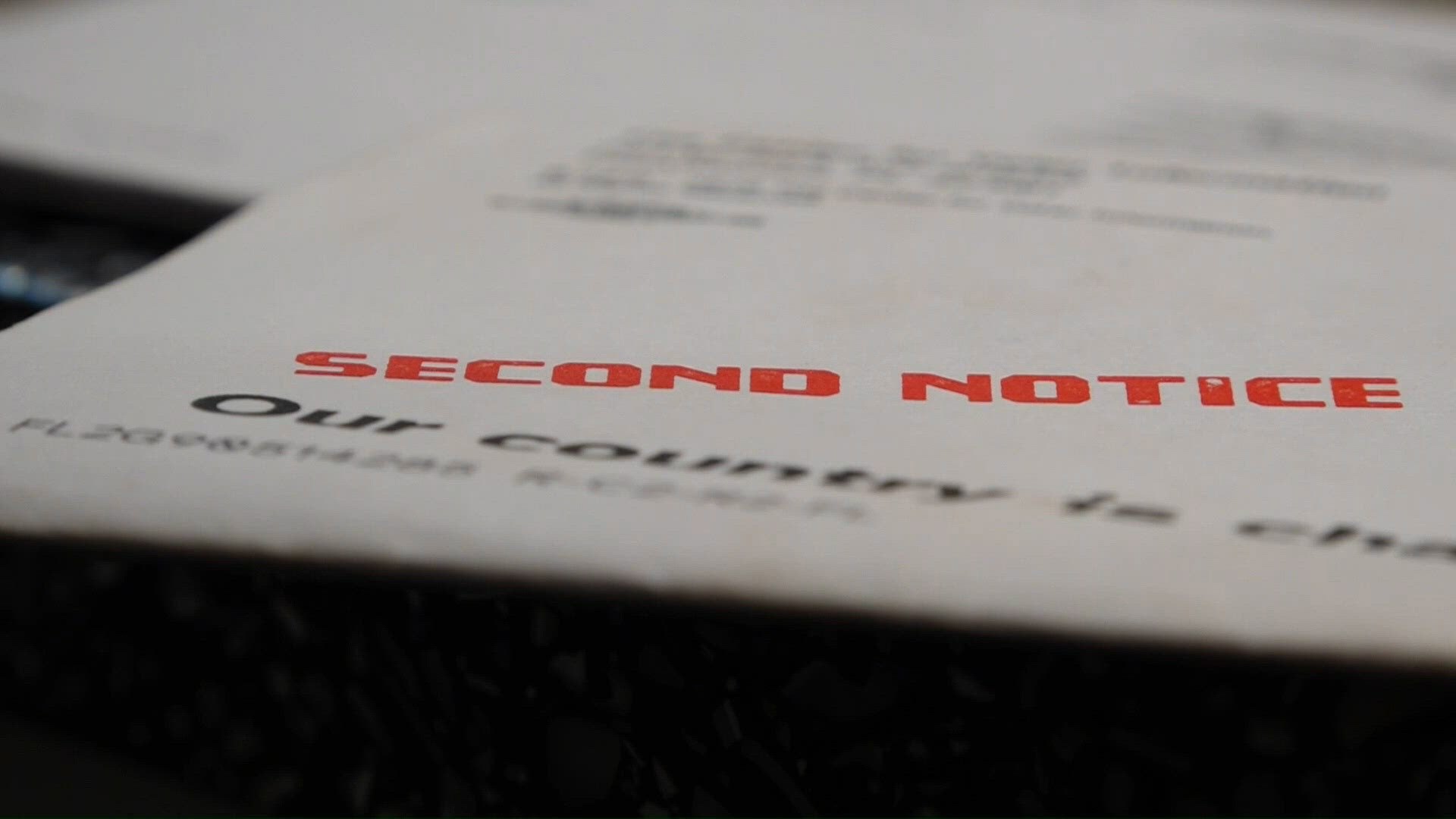 A white paper mailer stamped 'SECOND NOTICE' in large red capital letters.