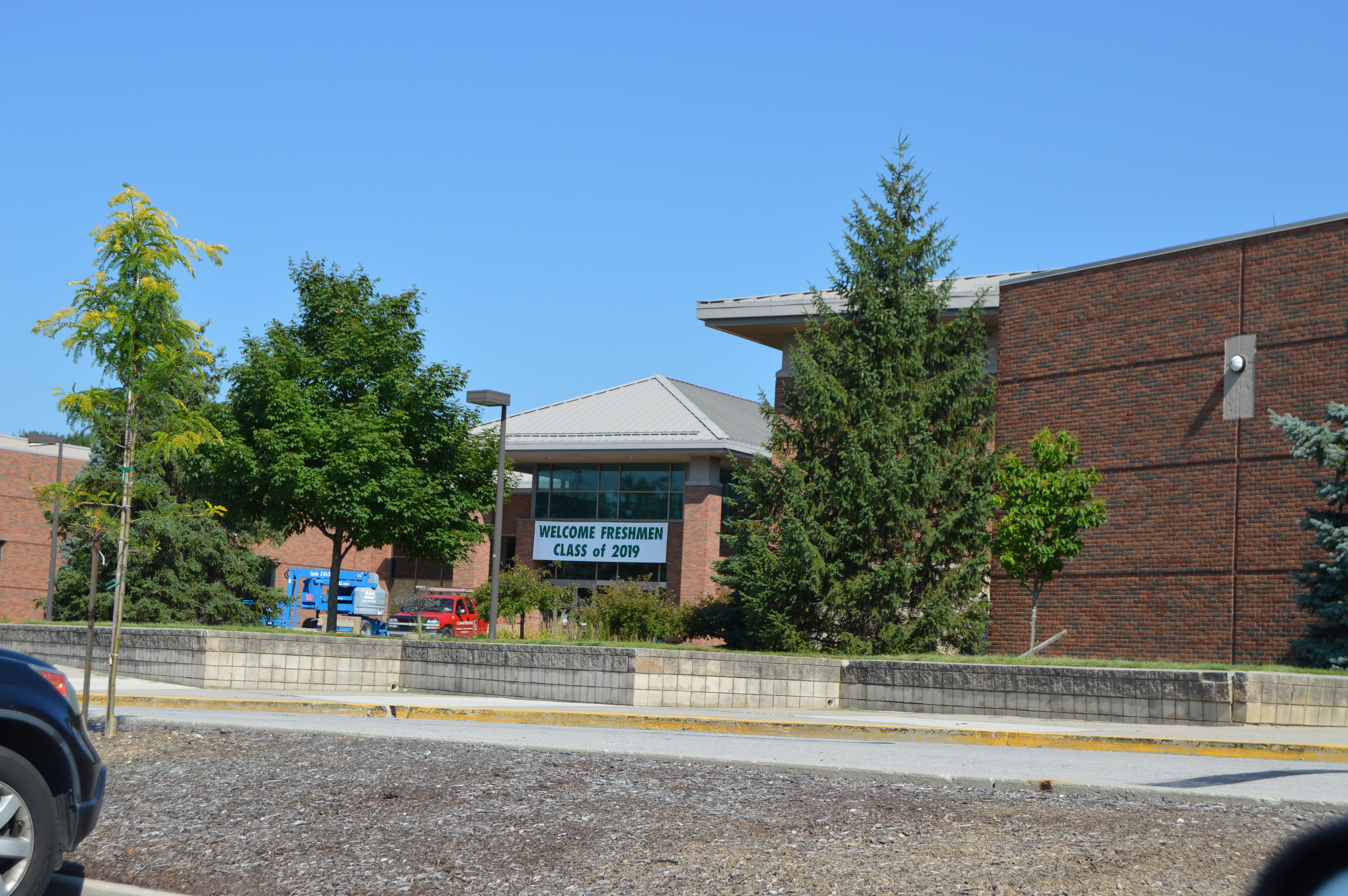 Brick exterior of Dublin Scioto High School under a clear blue sky.