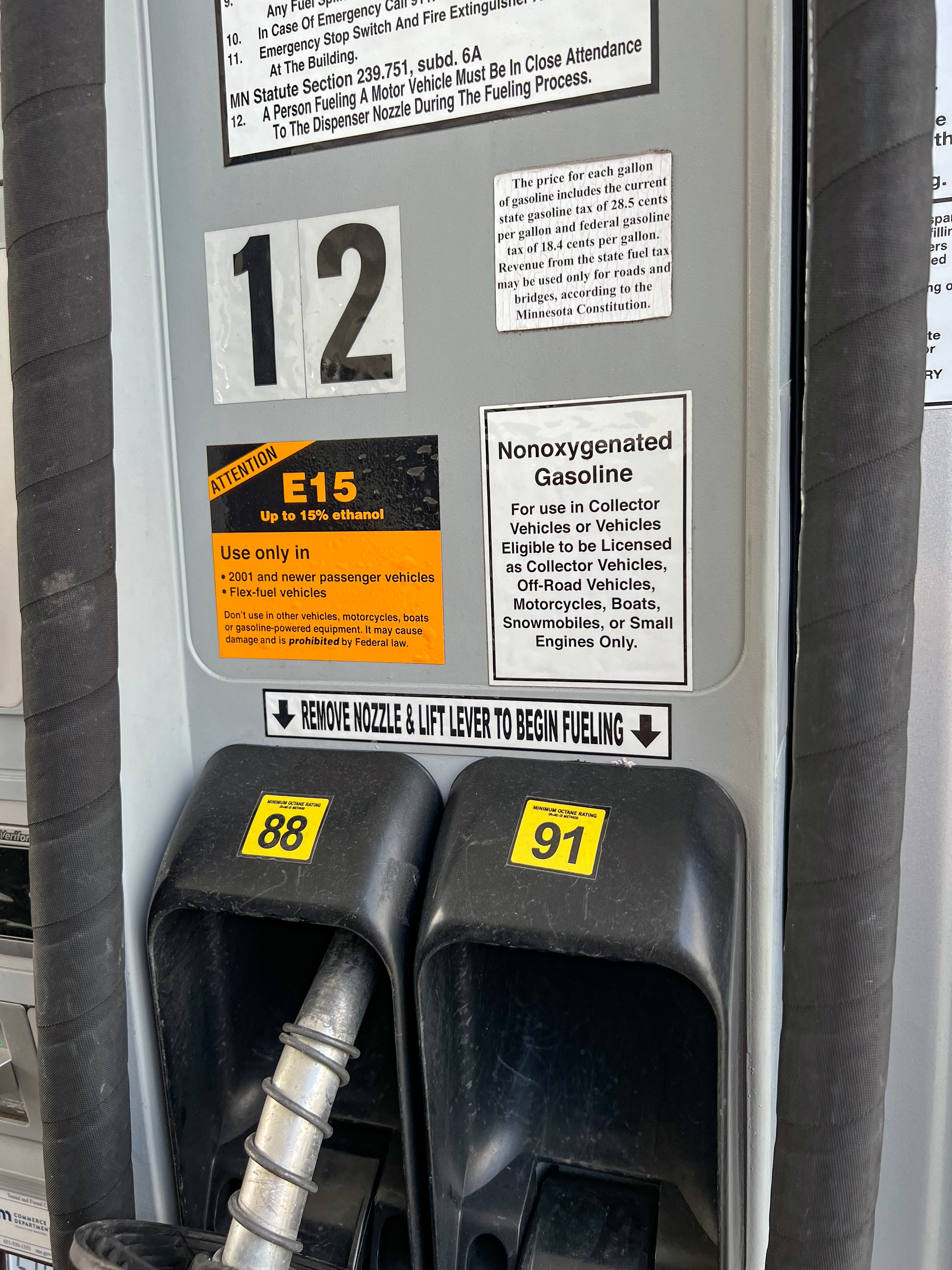 Two gas pump dispensers showing octane grade options at a self-serve station.