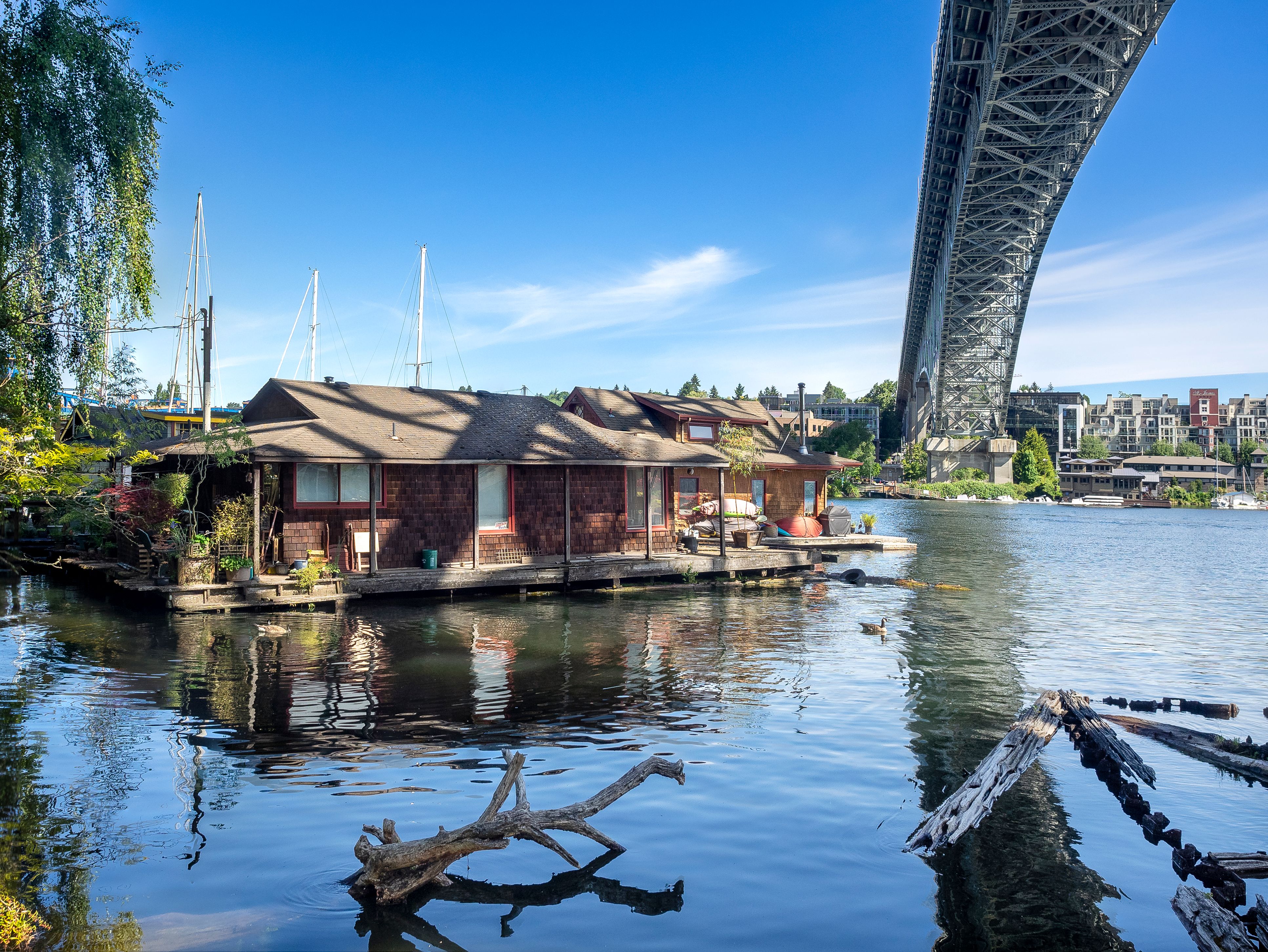 Floating homes and a large steel bridge along the Aurora Avenue corridor in Seattle.