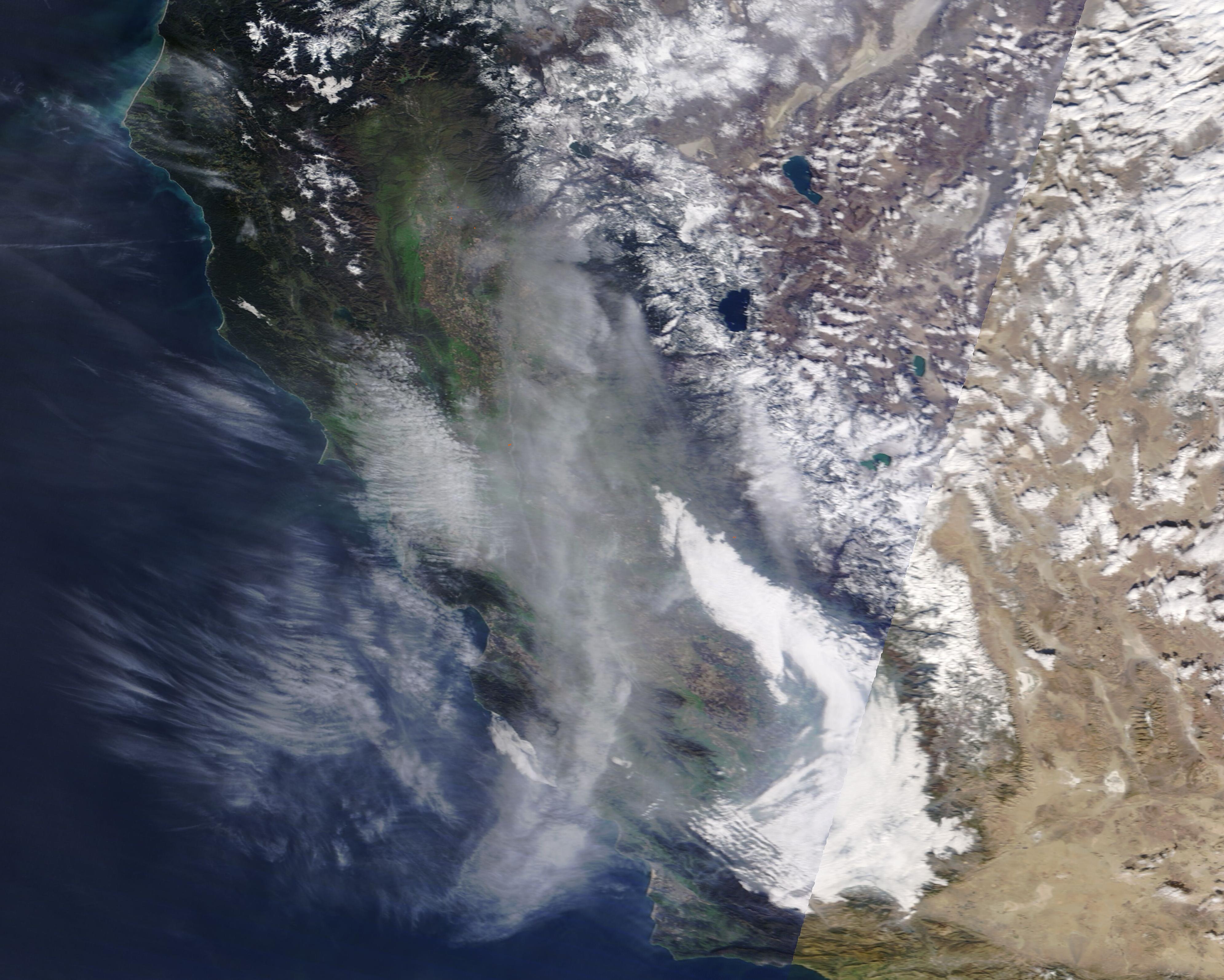 Satellite view of California coastline obscured by thick wildfire smoke and haze.