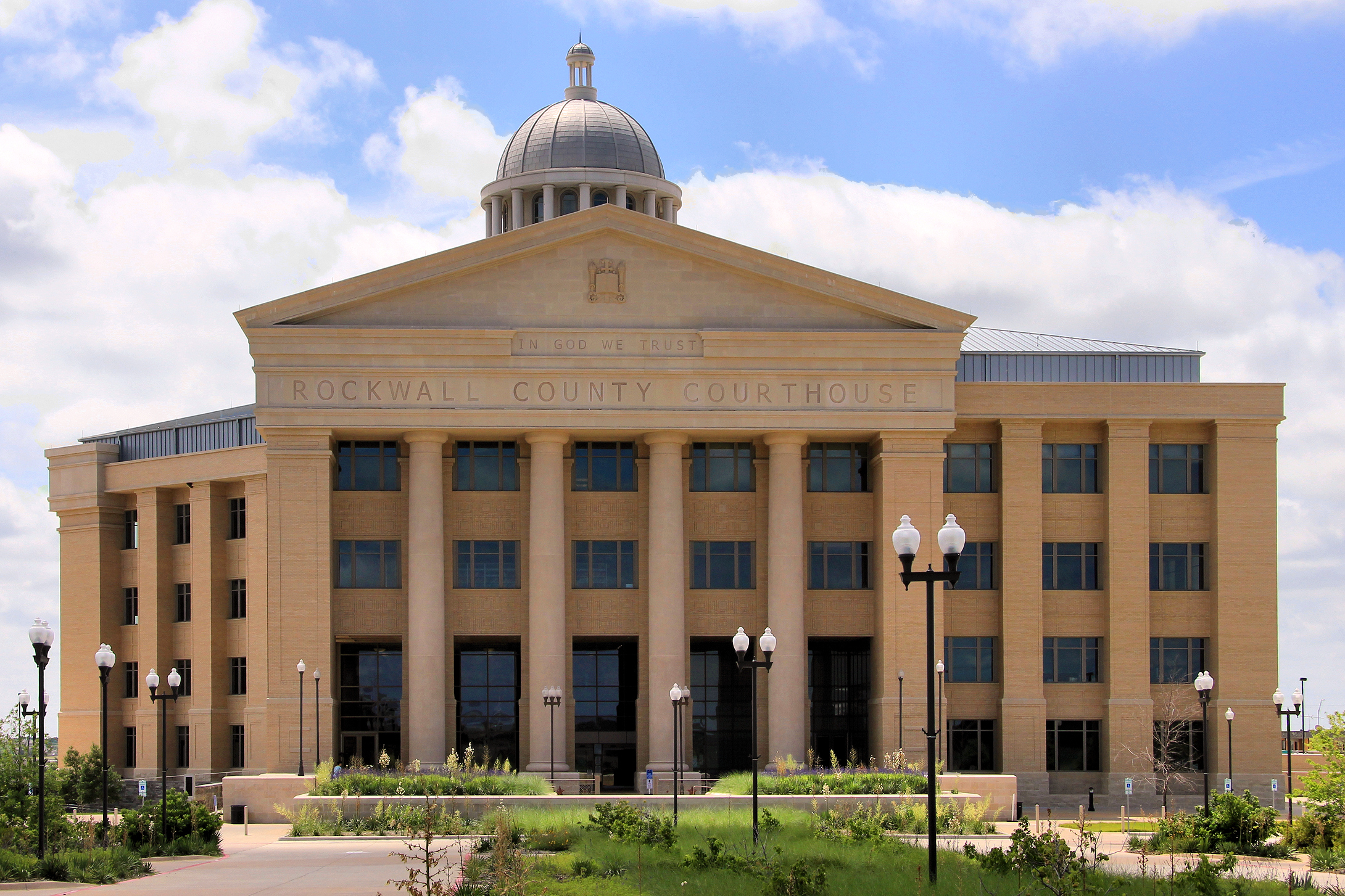 Neoclassical courthouse building with a central dome and columned entrance.