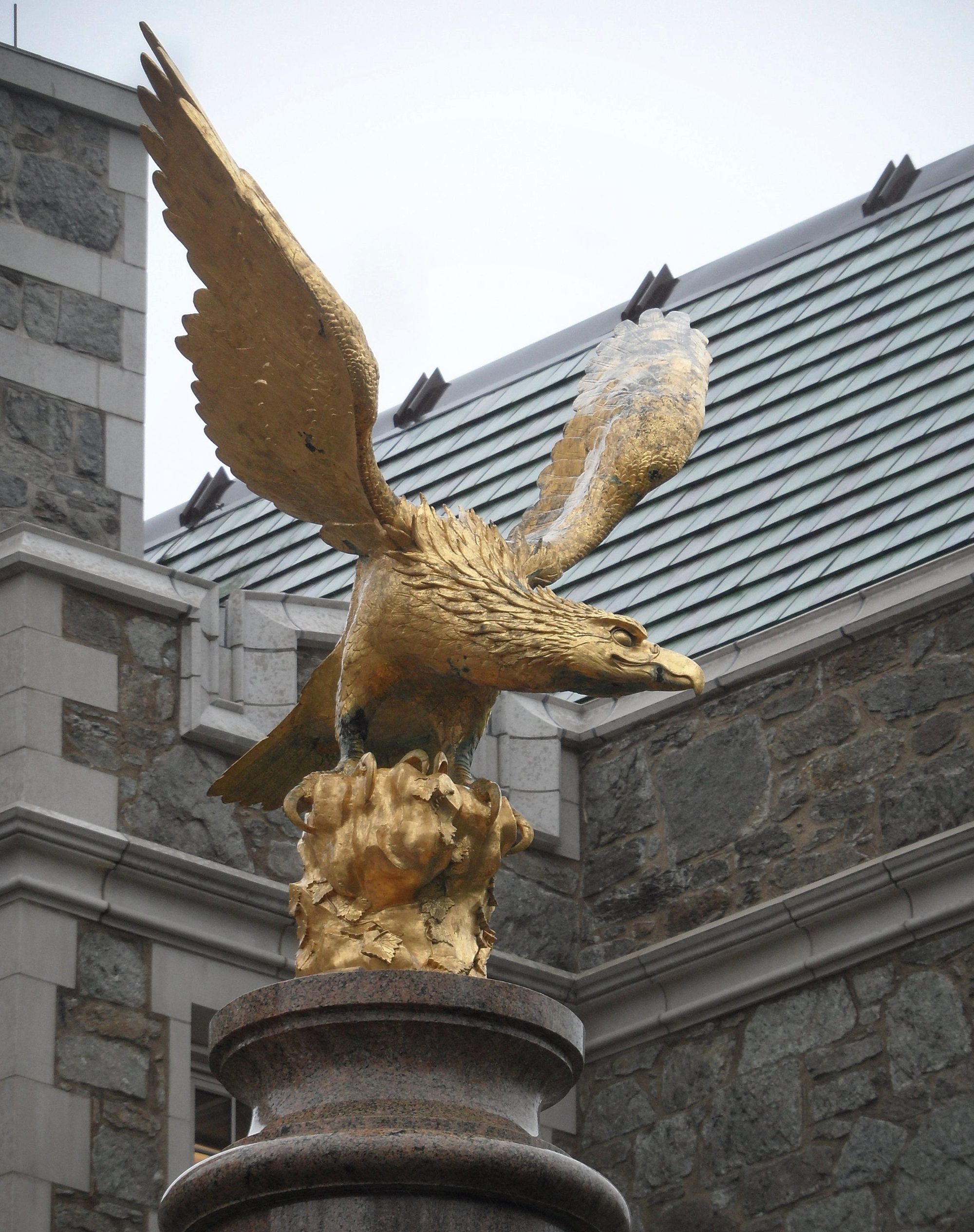 Newton, MA: Boston College, eagle sculpture on pillar, in front of Gasson Hall; in April 2019