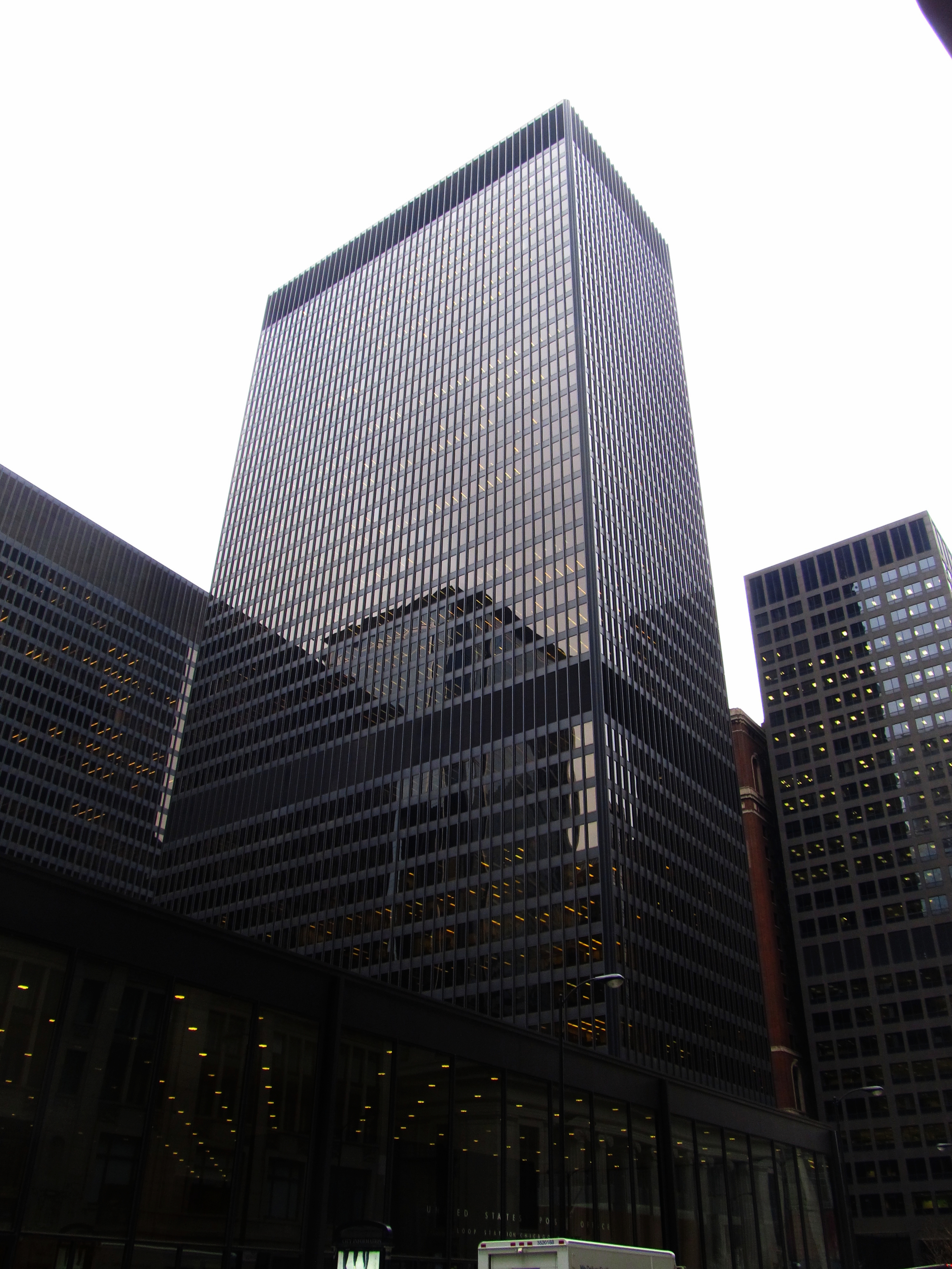 Tall modernist glass and steel federal building viewed from below at an angle.