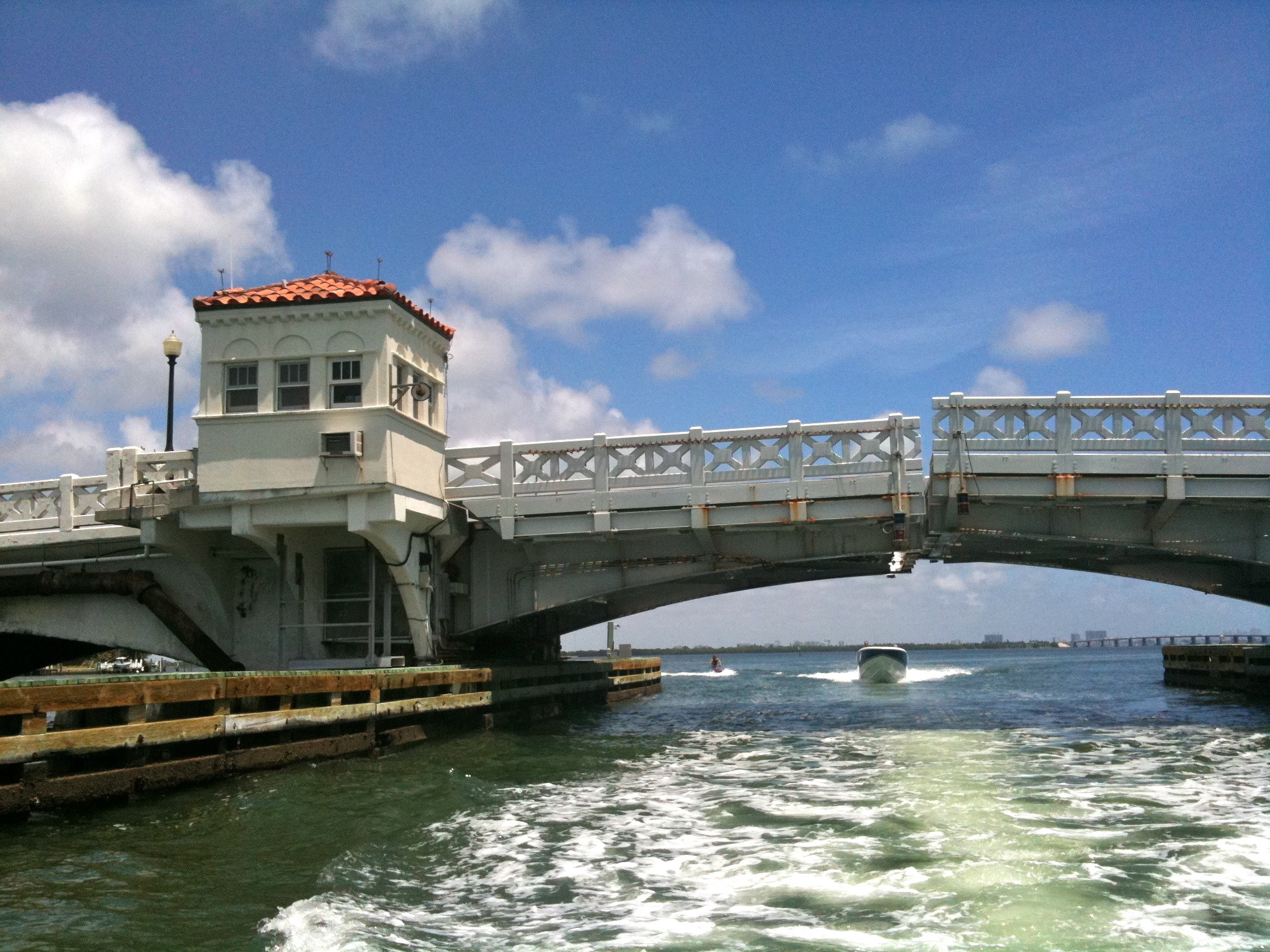 Historic bascule drawbridge on the Venetian Causeway spanning a waterway, control tower at left.