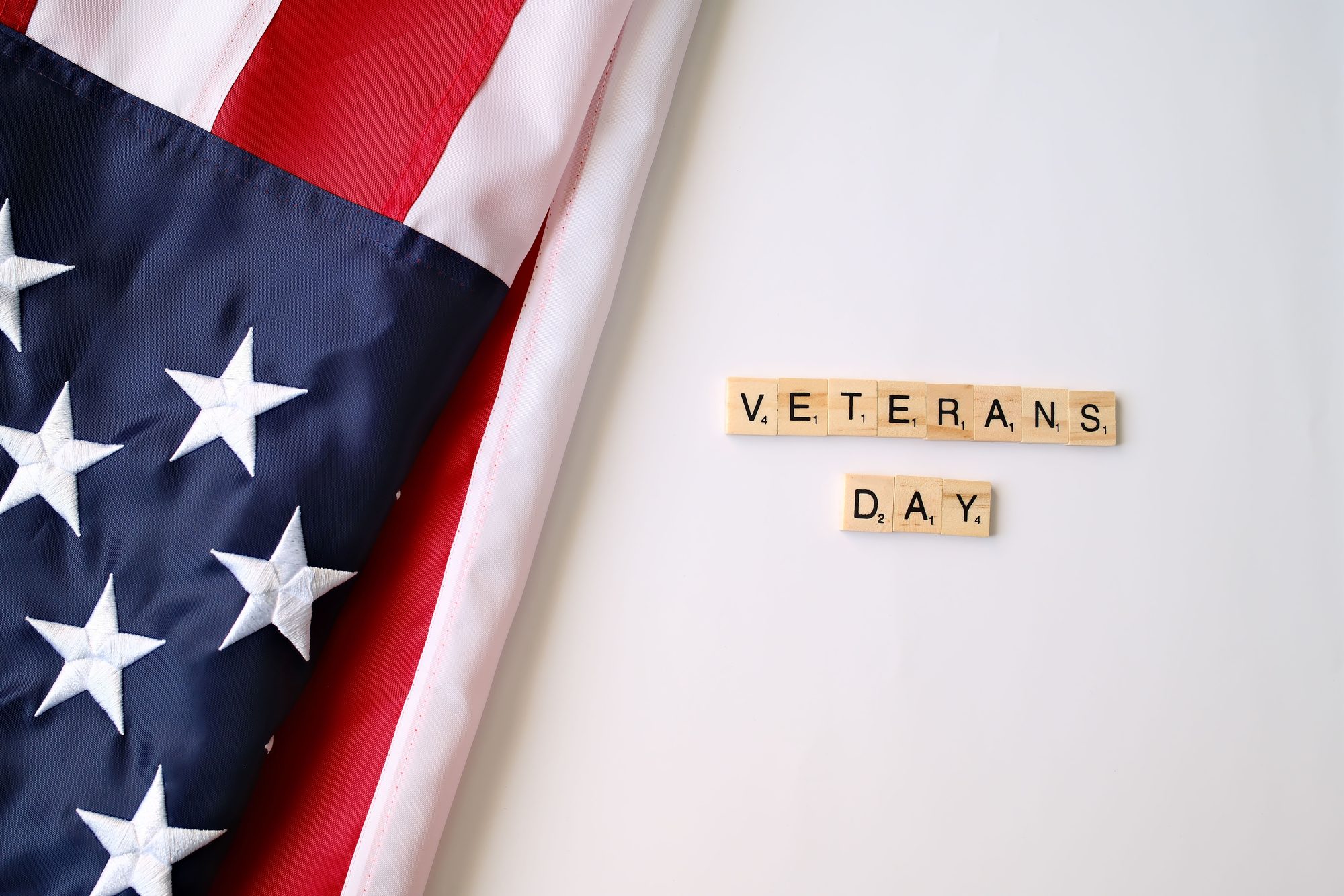American flag and Veterans Day text on tiles symbolizing honor and patriotism.