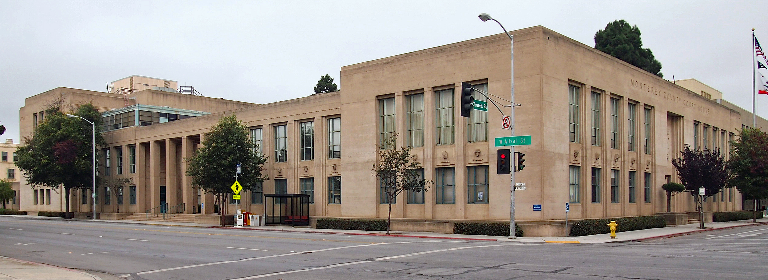 Neoclassical courthouse building with columns and an American flag on a flagpole
