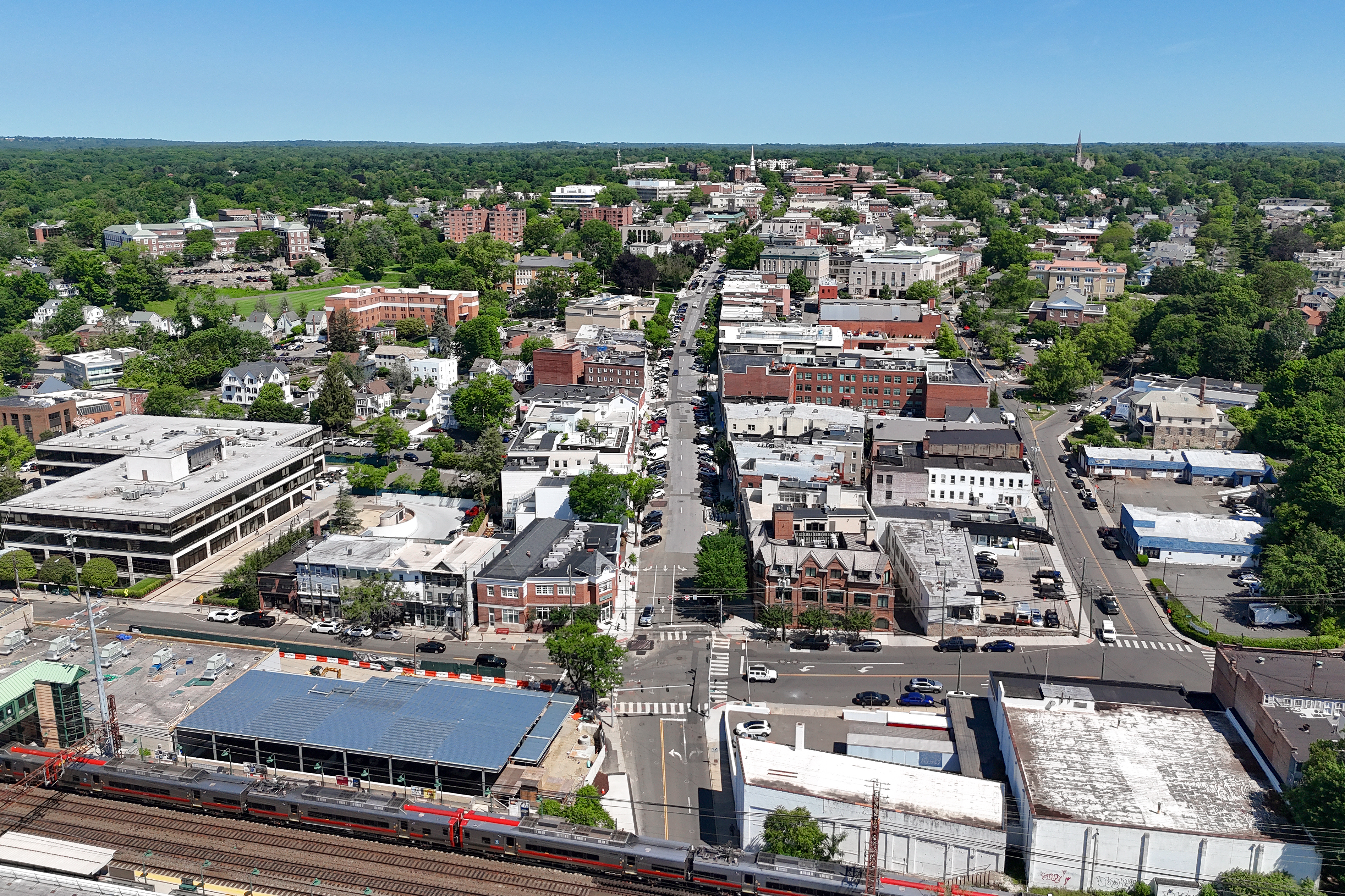 Aerial view of downtown Greenwich, Connecticut with brick buildings and tree-lined streets.