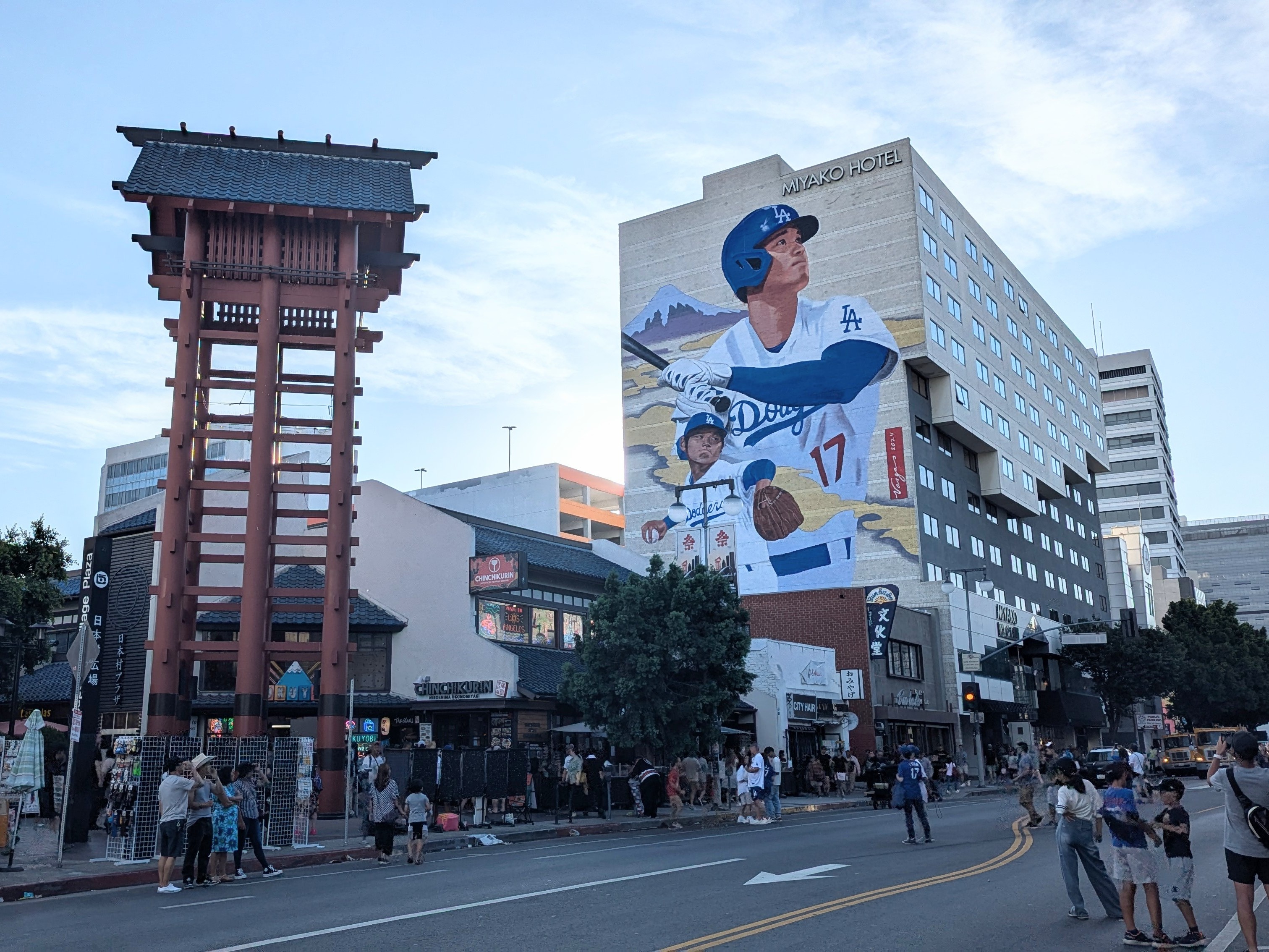 Little Tokyo street scene with a large building mural and a traditional Japanese-style tower structure in the foreground.