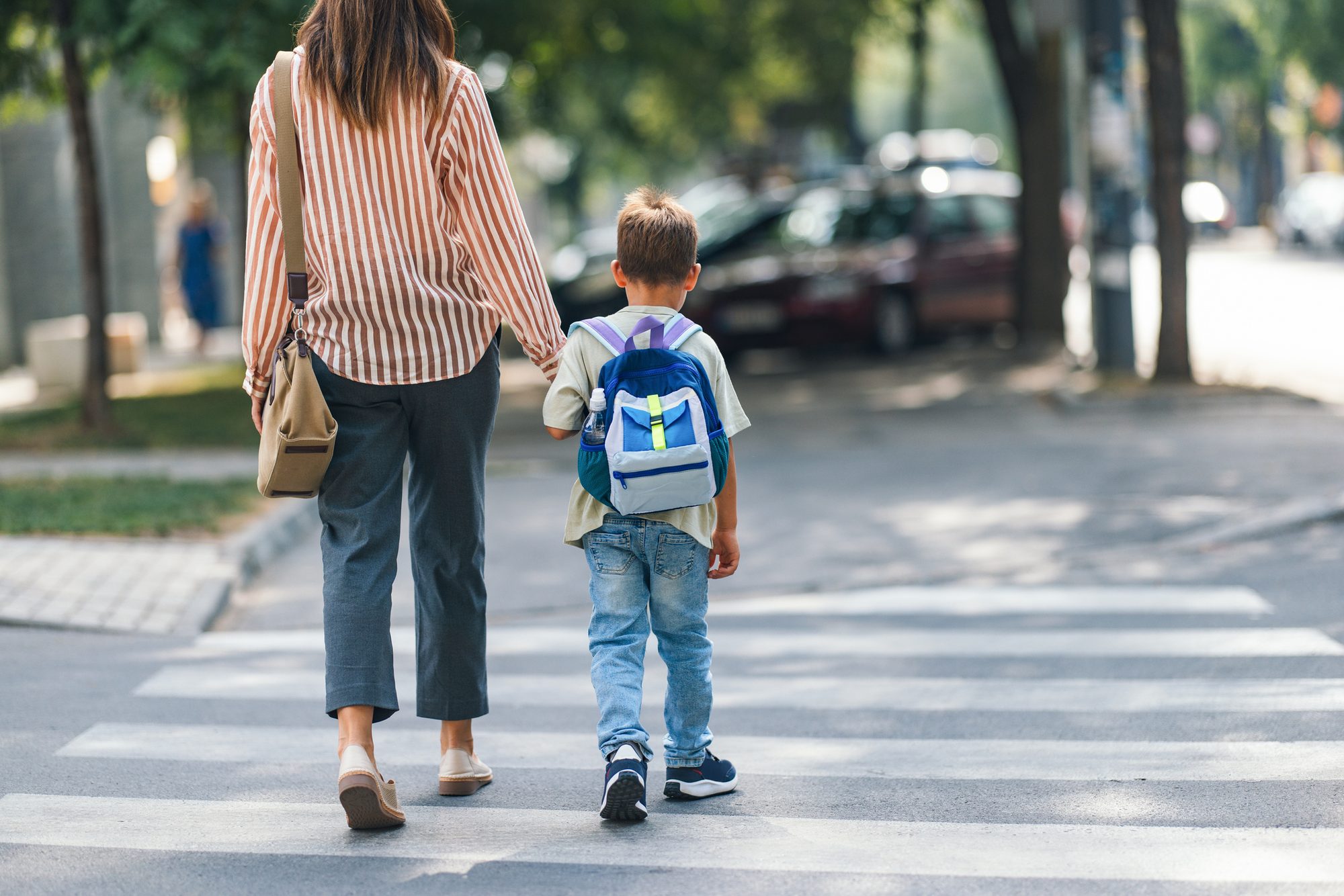 Mom Walking Son to Elementary School on First Day Back