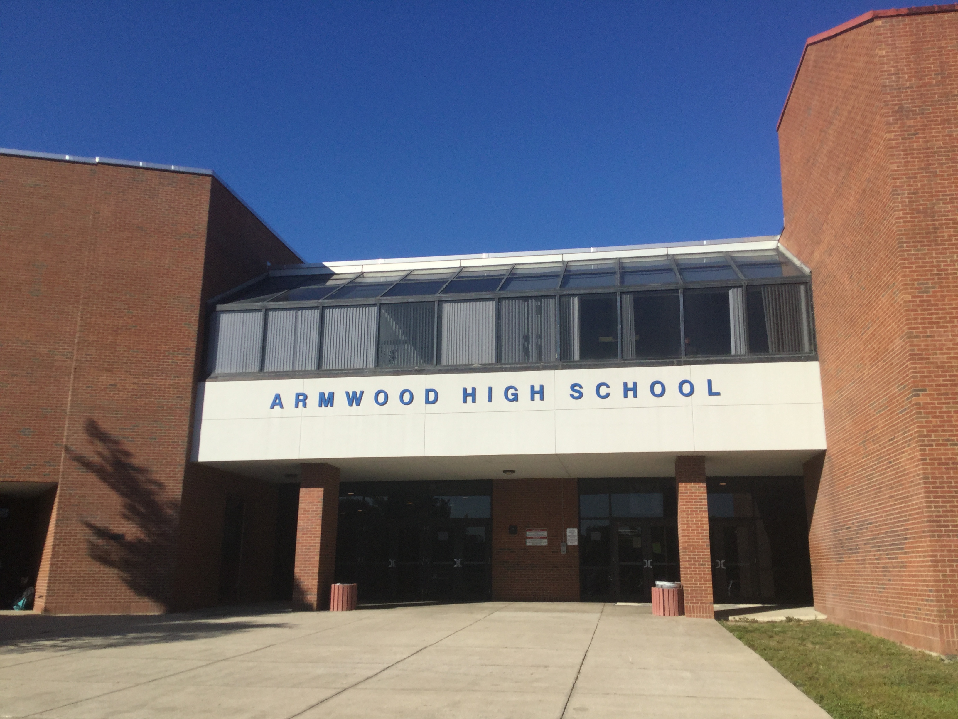 Brick exterior and main entrance of Armwood High School under a clear blue sky.