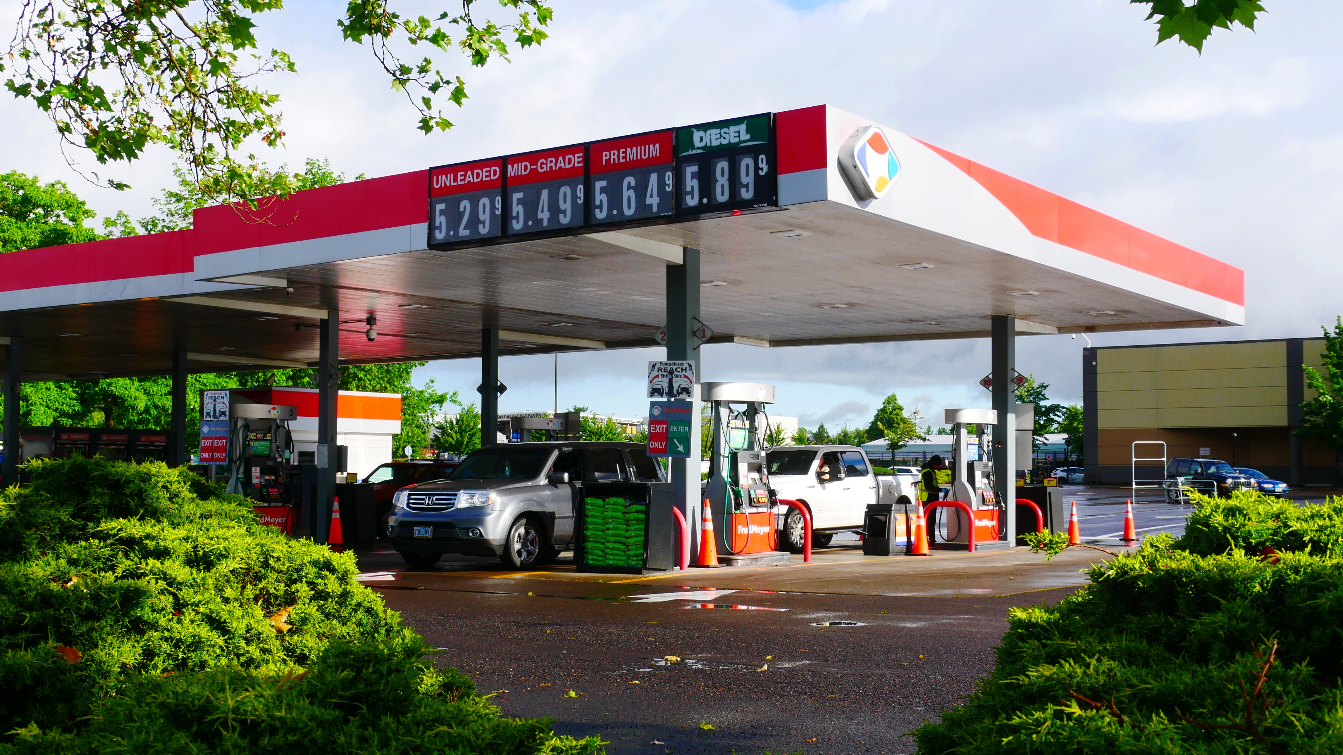 Gas station price board showing regular unleaded above five dollars per gallon.