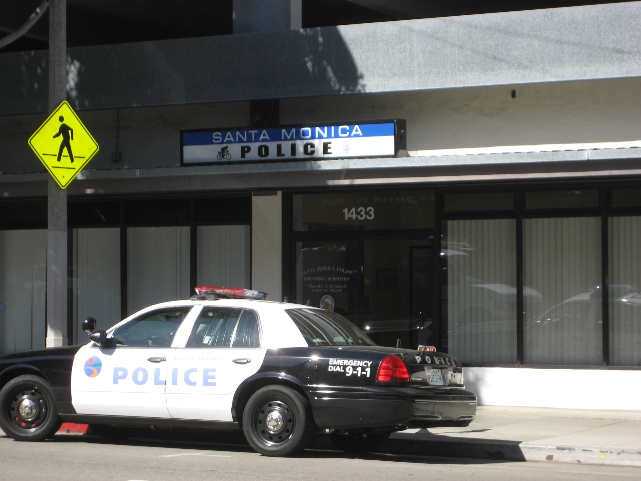 Santa Monica Police patrol car parked in front of the police station building.