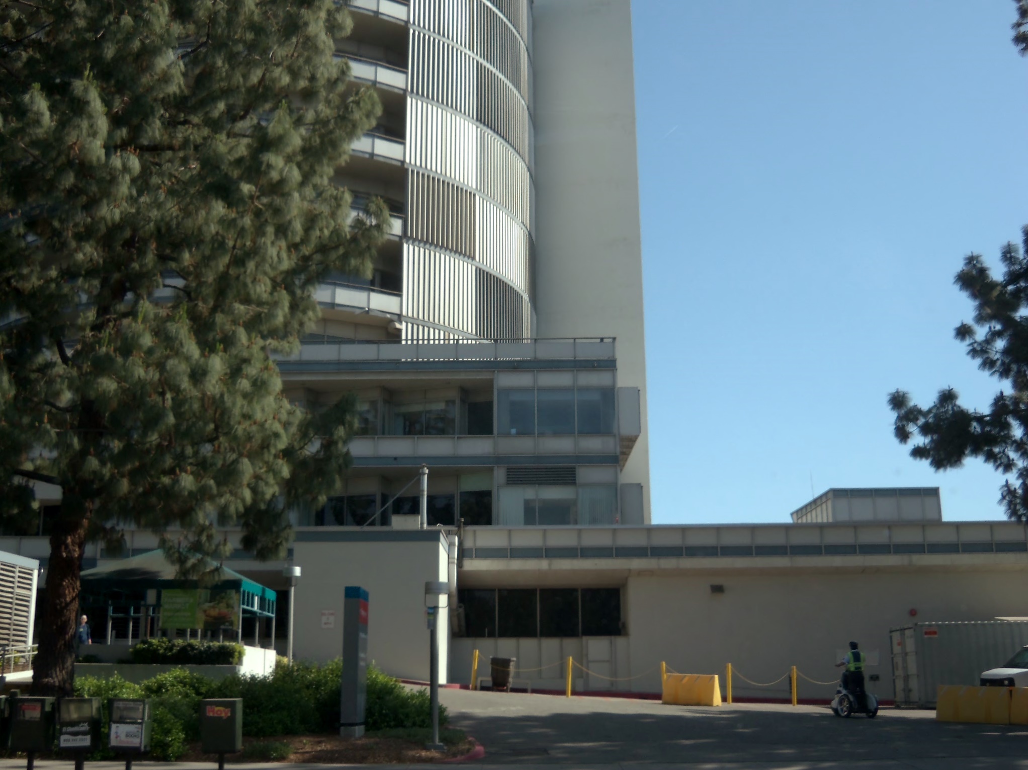 Multi-story Kaiser Permanente Medical Center building with an emergency entrance and trees.