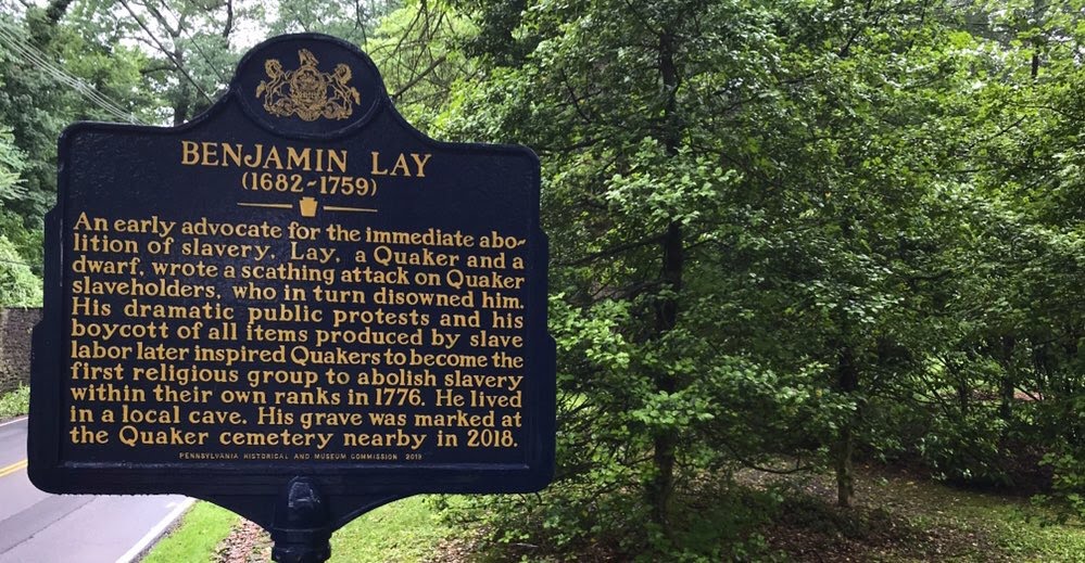Black and gold Pennsylvania historical marker for Benjamin Lay mounted on a post outdoors.