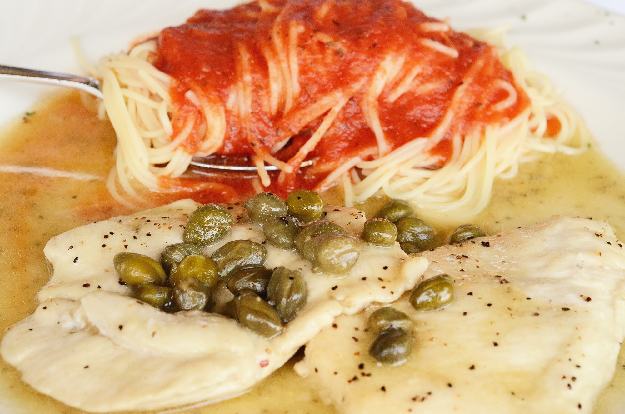 Chicken piccata with capers & white wine with capellini & tomato sauce at Bongiorno Italian Restaurant in Mountain Brook, Alabama. Had it for lunch today.
