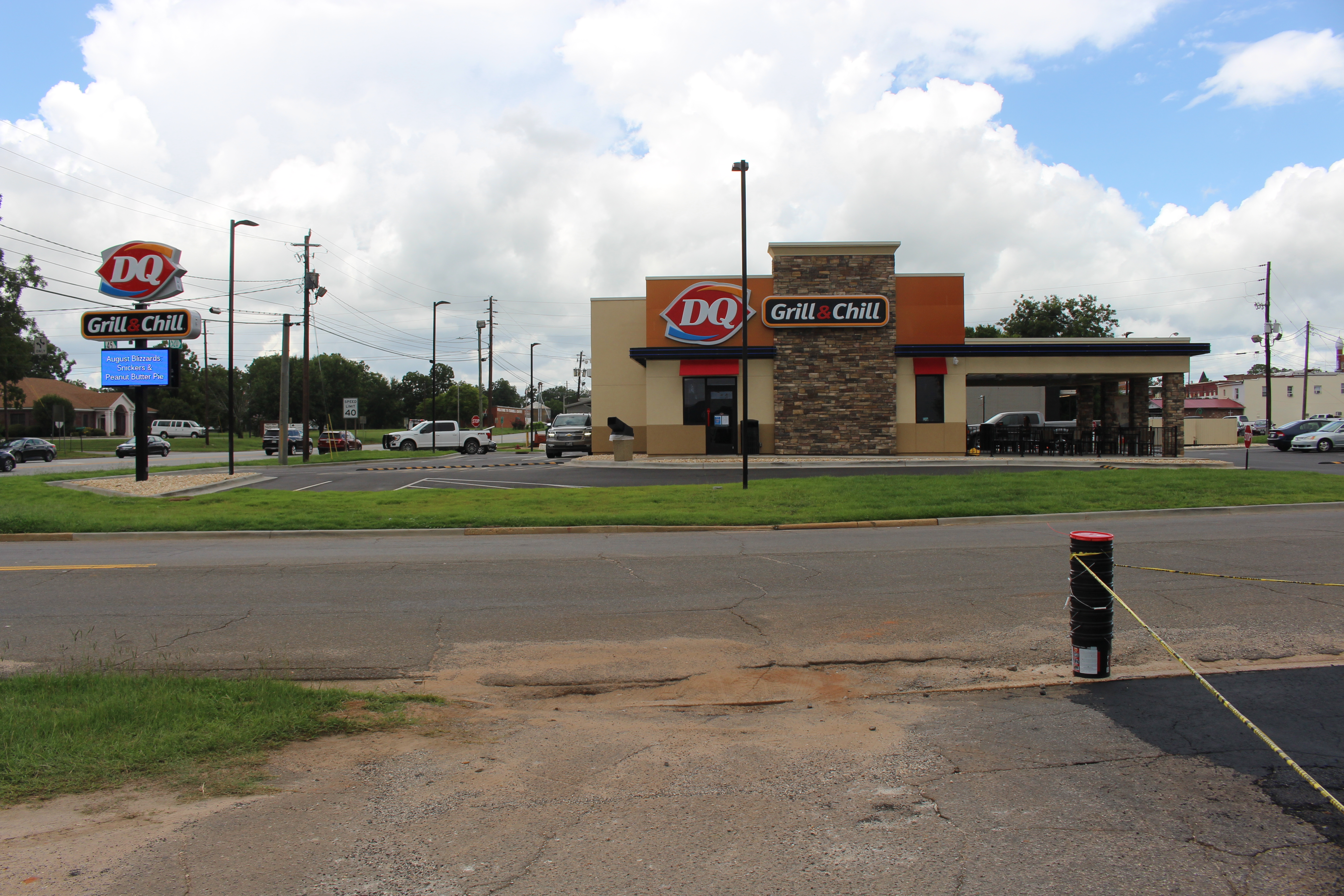 Dairy Queen Grill and Chill restaurant with stone facade, drive-thru lane, and parking lot.