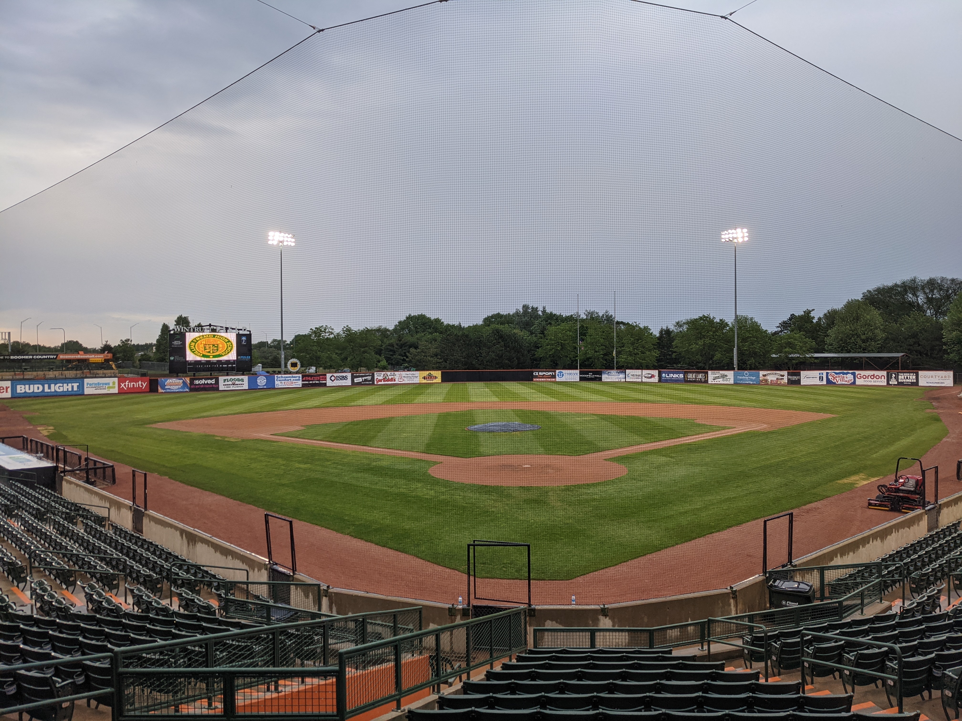 Empty minor league baseball stadium interior showing the diamond, outfield, and scoreboard.