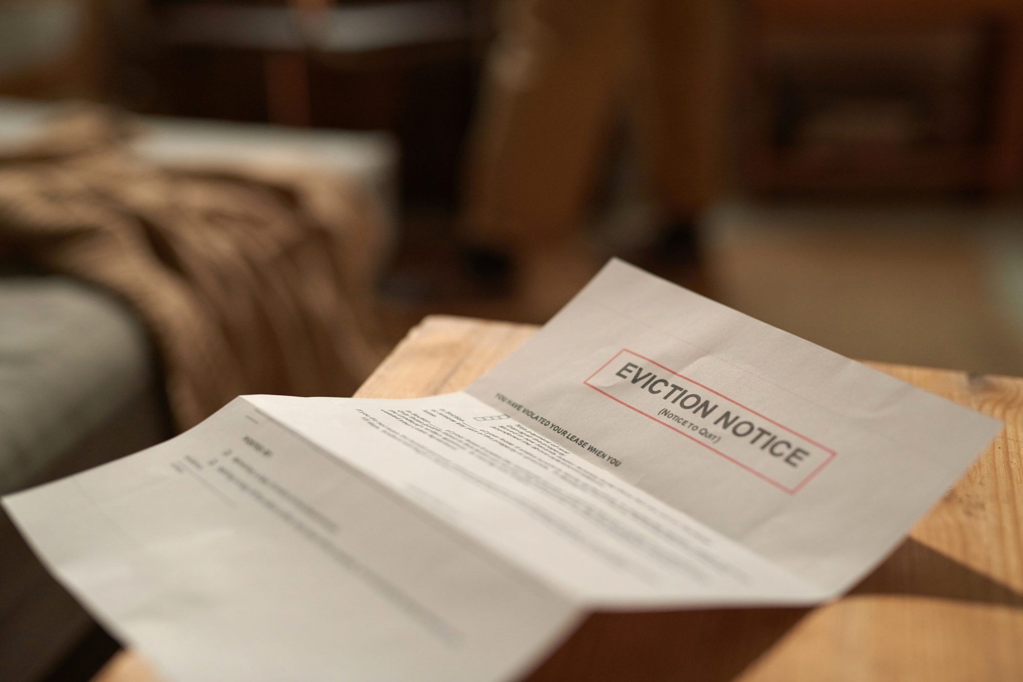 Room Eviction Notice Placed On Wooden Desk