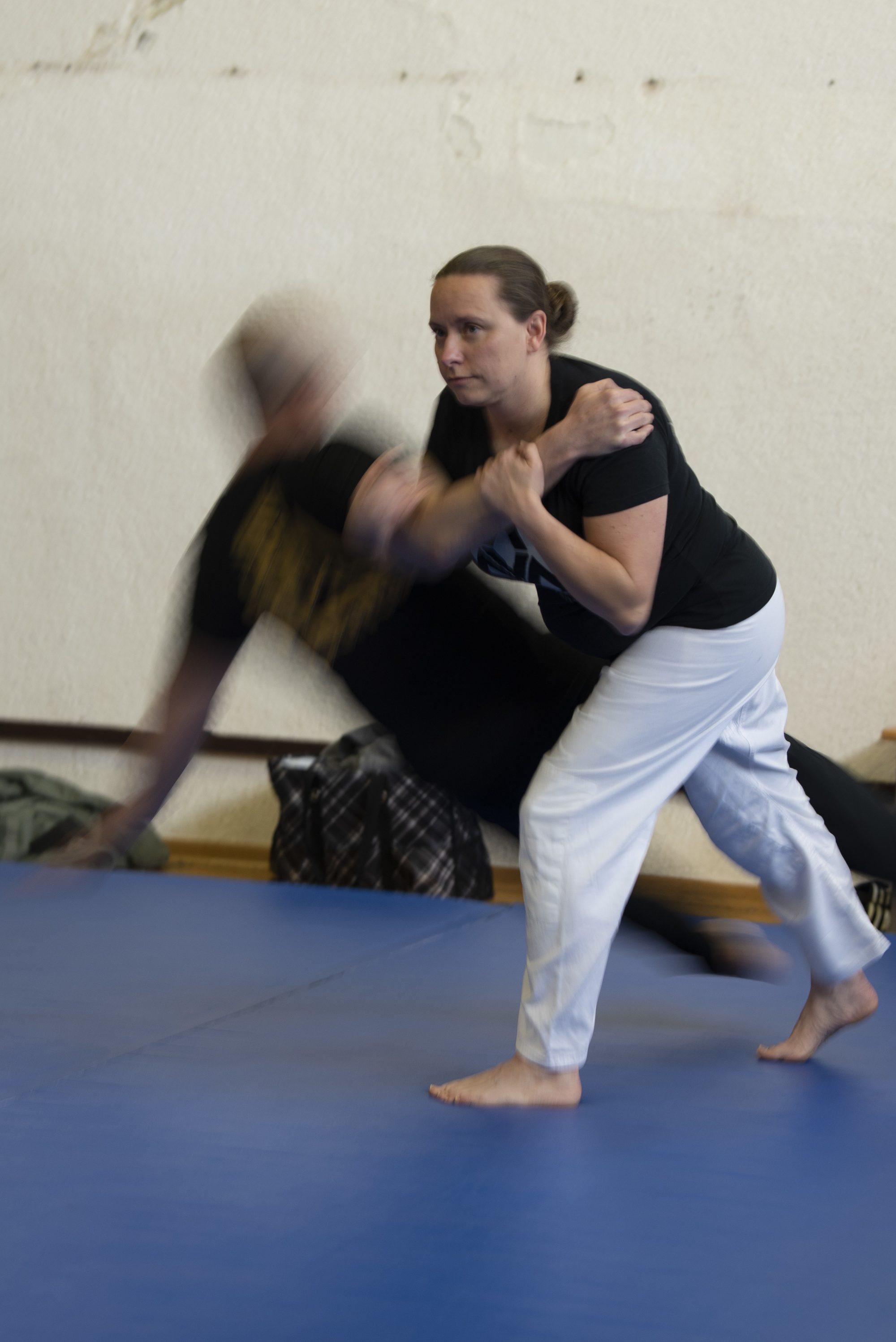 U.S. Air Force Master Sgt. Sherry Riba, 52nd Maintenance Squadron unit deployment manager, throws Tech. Sgt. Jeffery Frederick, 52nd MXS NCO in charge of non-destructive inspection, during a self-defense course, at Skelton Gym on Spangdahlem Air Base, Germany, Feb. 6, 2019. Riba demonstrates it is possible to escape an attacker when being choked from behind. (U.S. Air Force photo by Airman 1st Class Branden Rae)