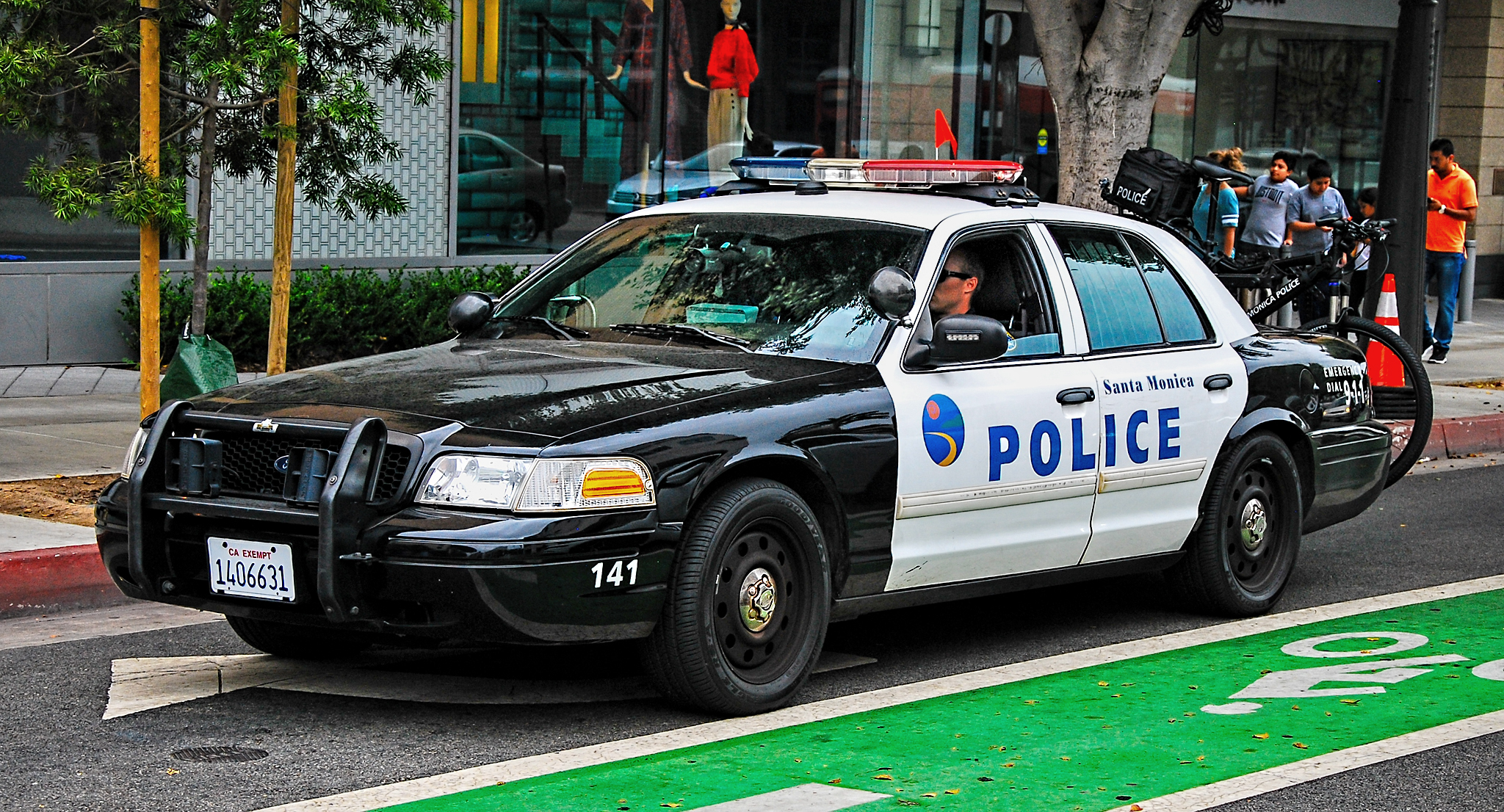 Black-and-white Santa Monica Police Department patrol car stopped on a city street.
