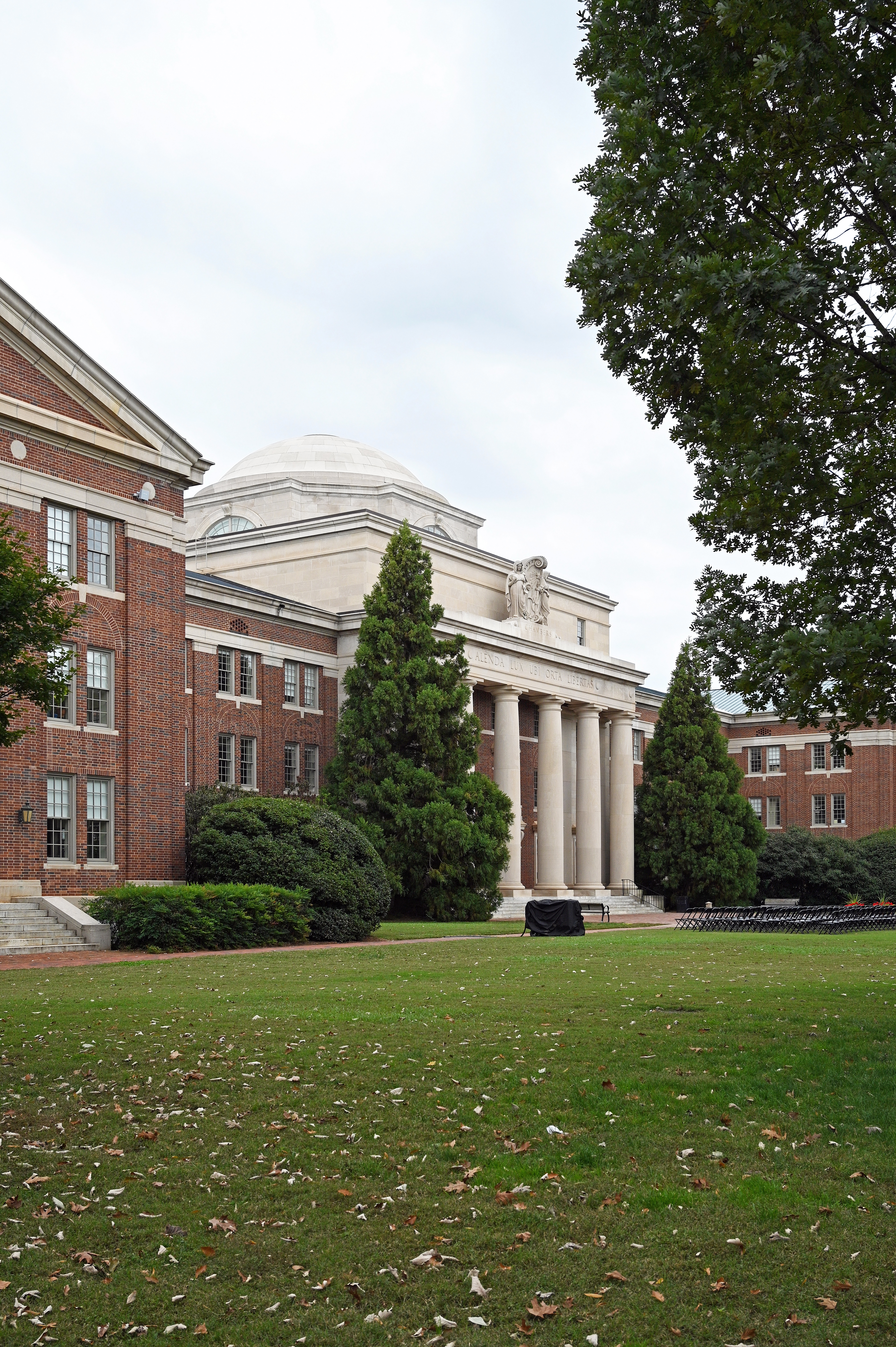 Neoclassical domed building with white columns on a college campus.