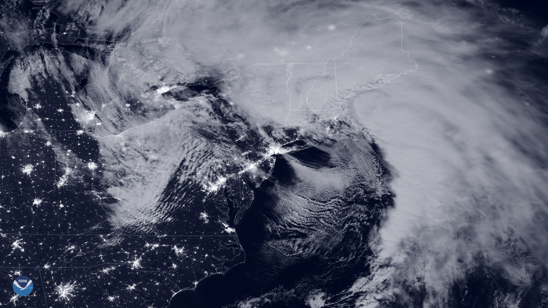 Satellite night image of a large spiral storm system over the northeastern United States.