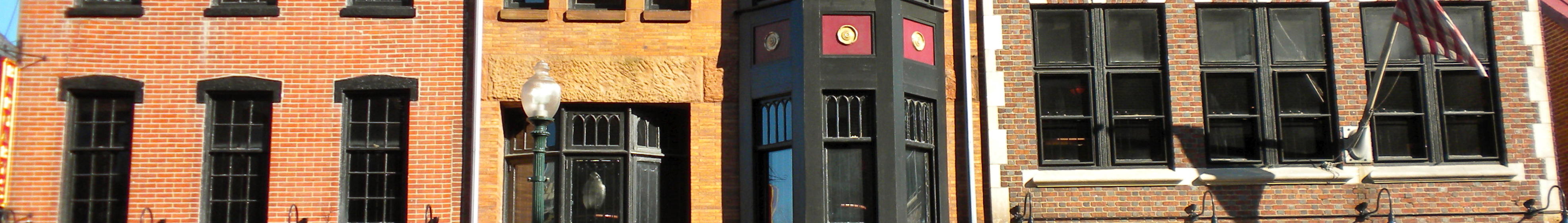 A row of historic brick commercial buildings lining a street in downtown West Chester, Pennsylvania.