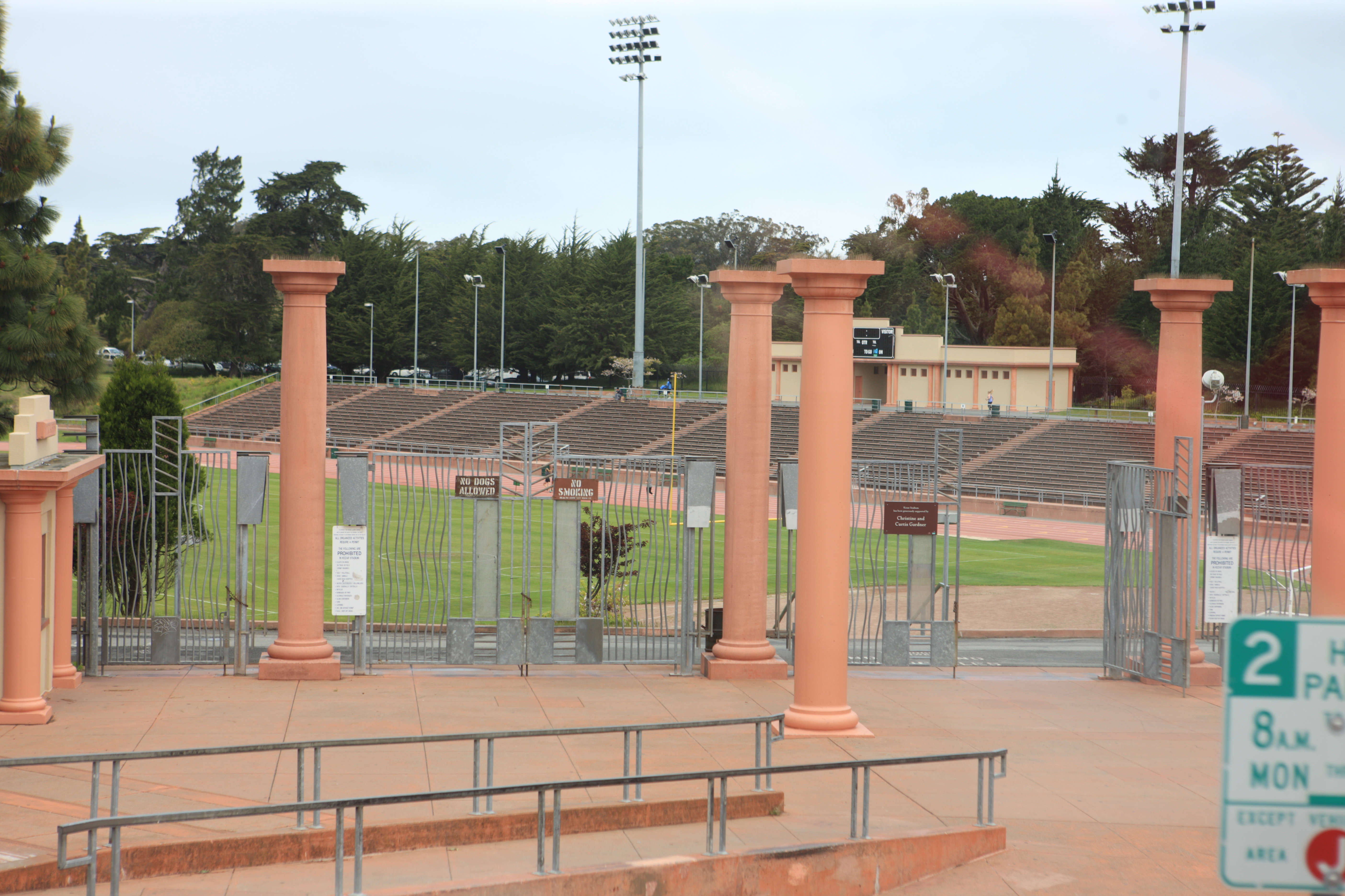 Exterior entrance of Kezar Stadium with terracotta columns and iron gates.