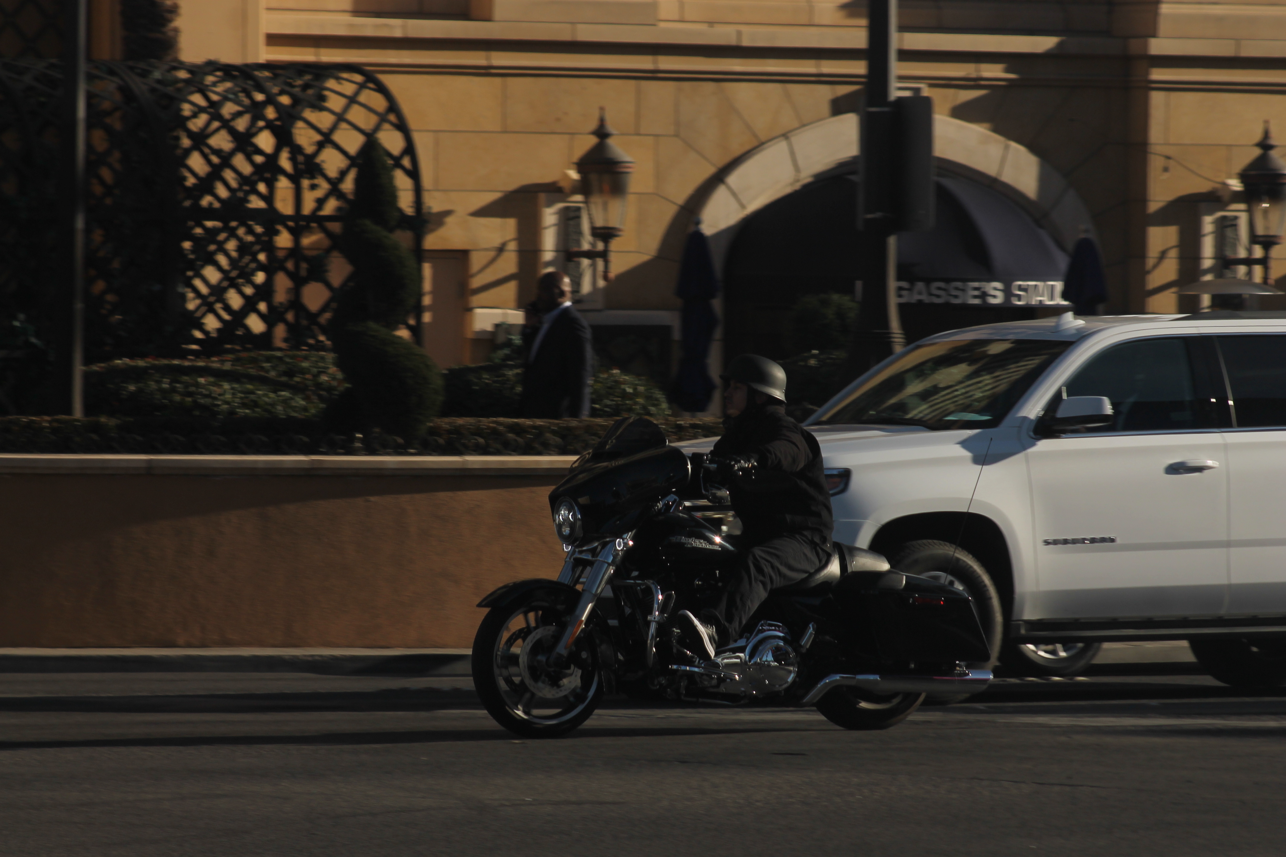 A rider on a Harley-Davidson Street Glide motorcycle moving through an intersection.