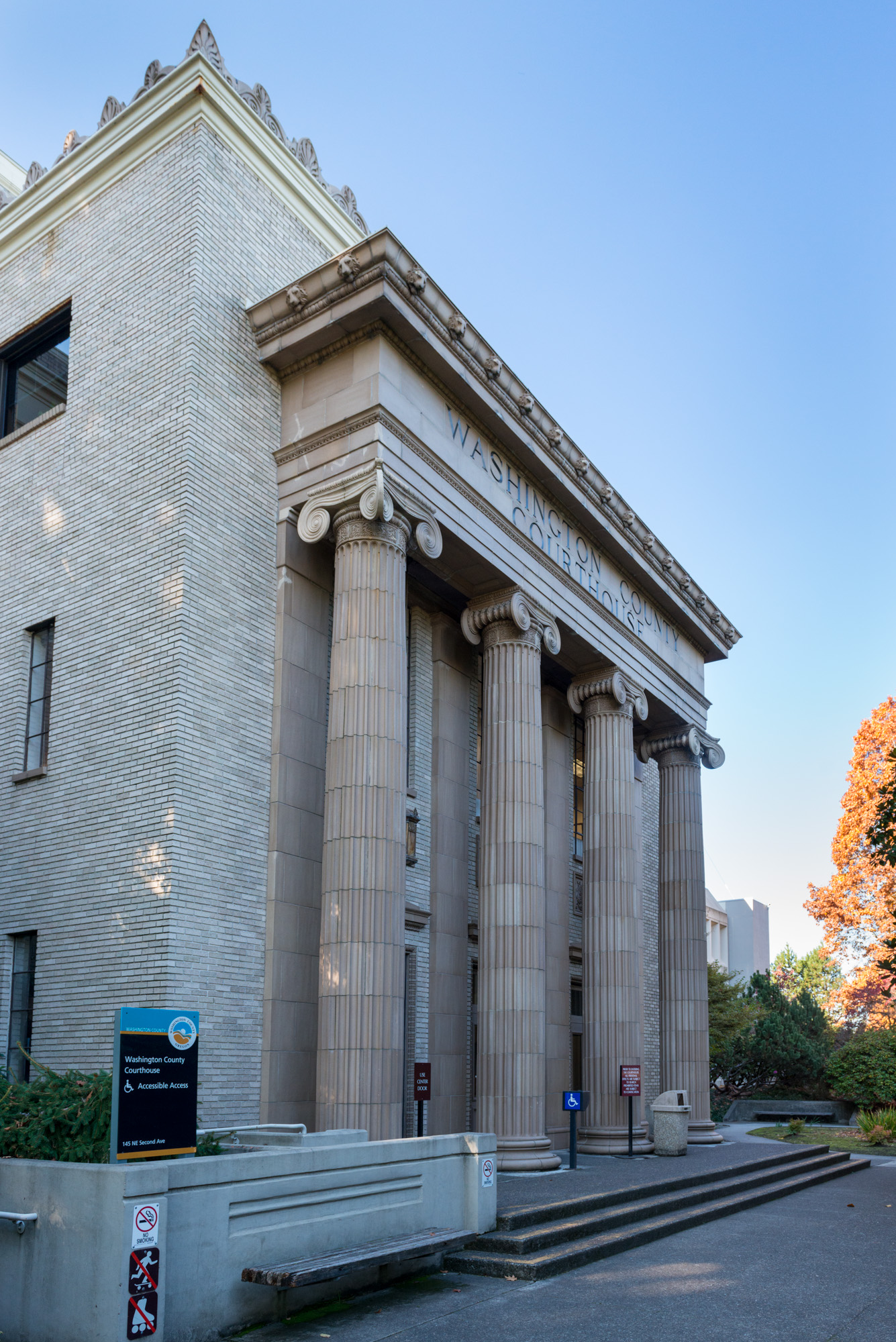 Close-up of large stone columns on a government courthouse facade with partial county name visible.