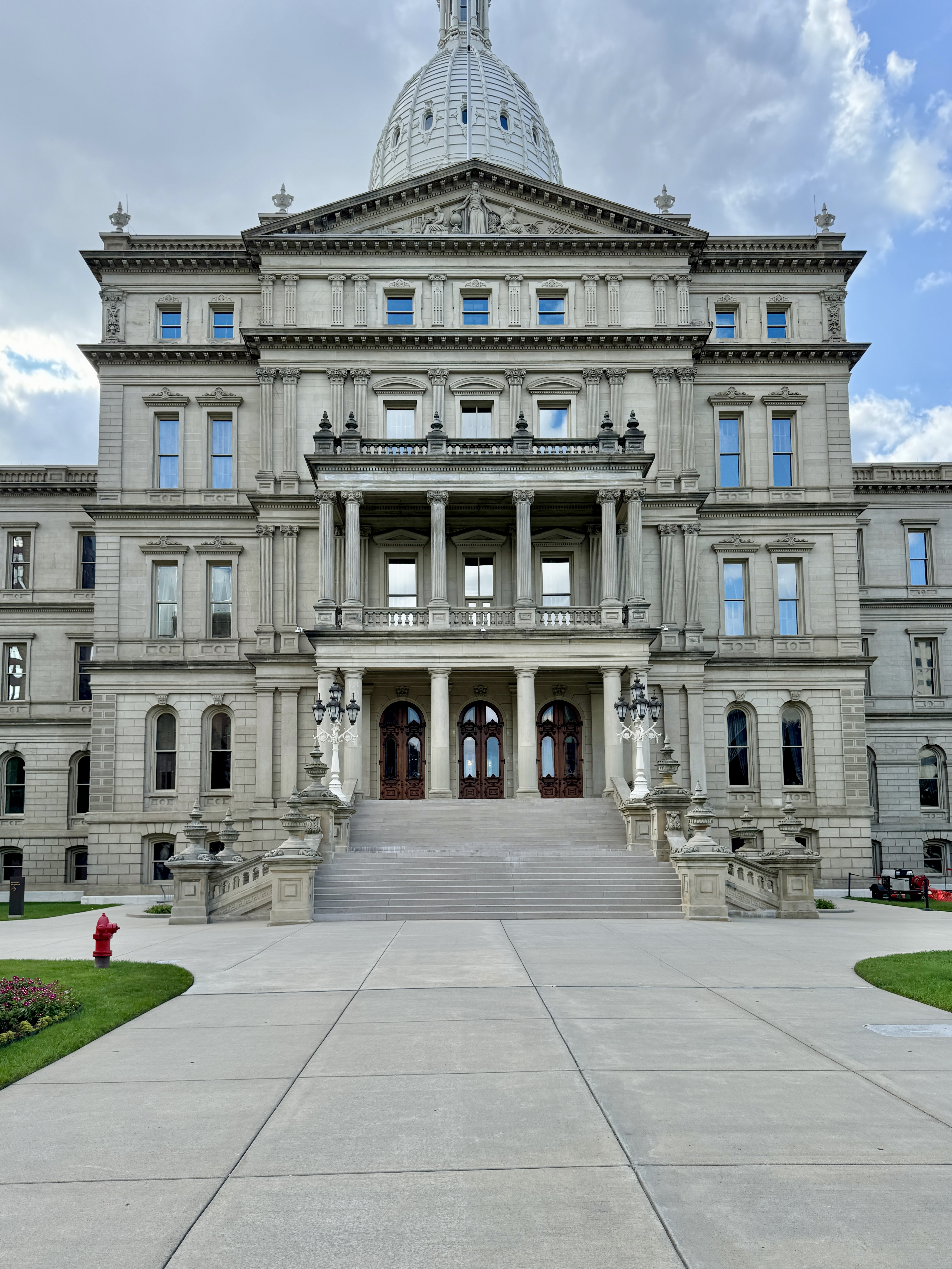 Front facade of the Michigan State Capitol building with its limestone exterior and central dome.