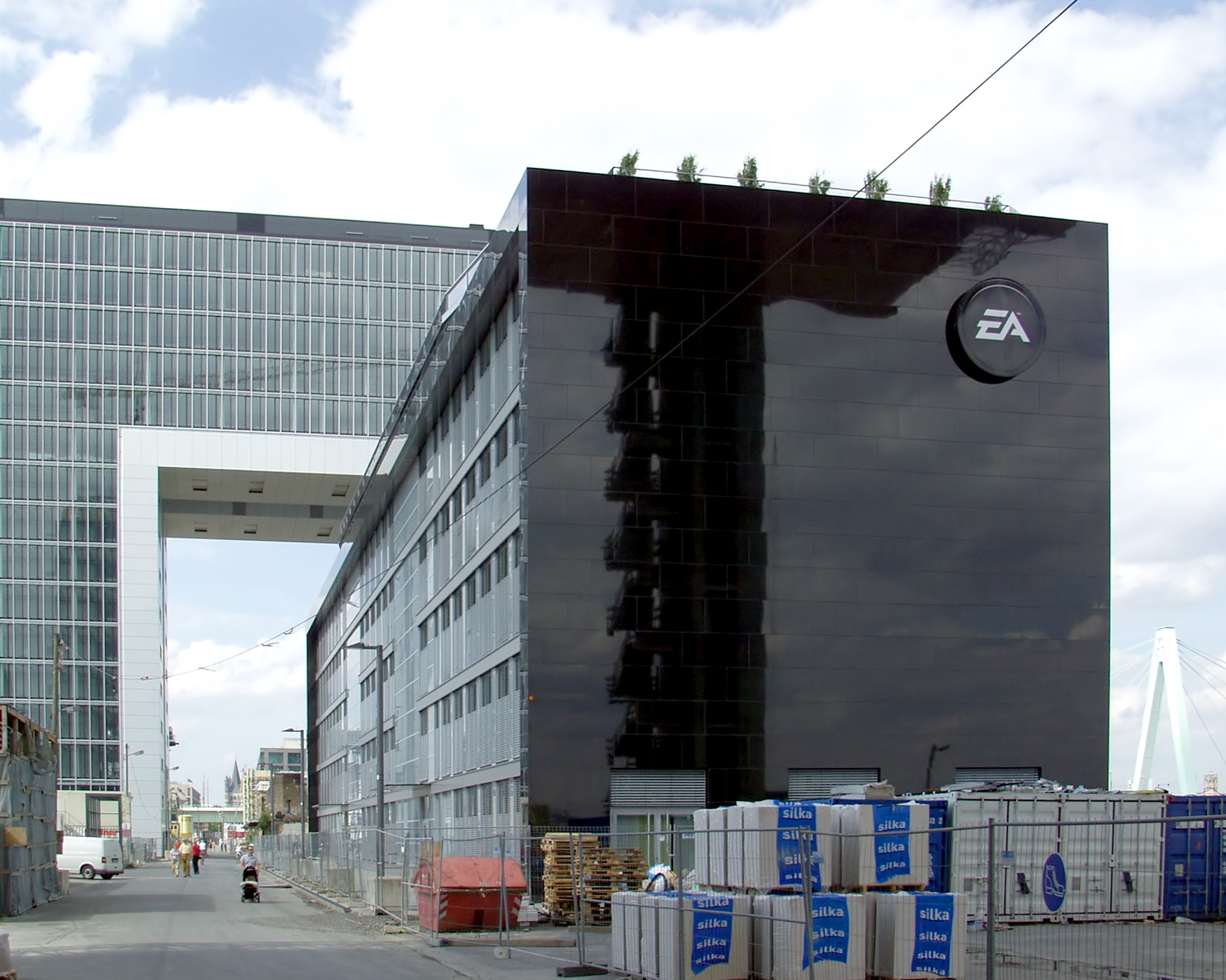 Office building with a large Electronic Arts EA logo on dark glass exterior.