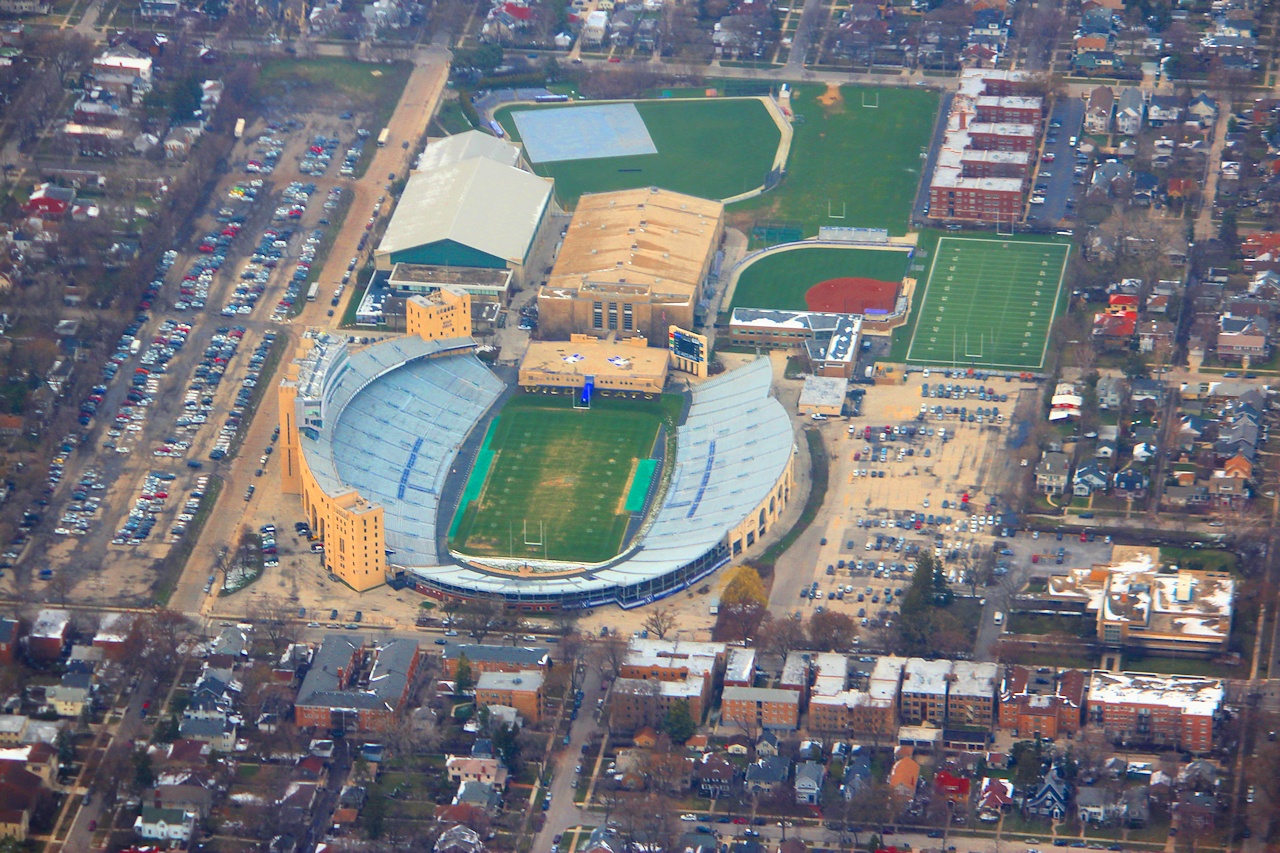 Aerial view of a college football stadium surrounded by dense residential neighborhoods.