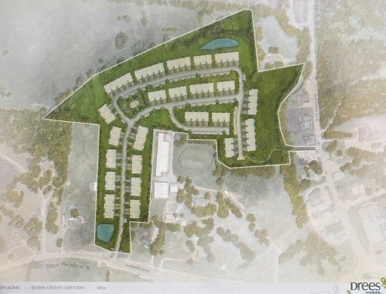 Aerial site plan rendering of a residential development with rows of units, roads, and two ponds.