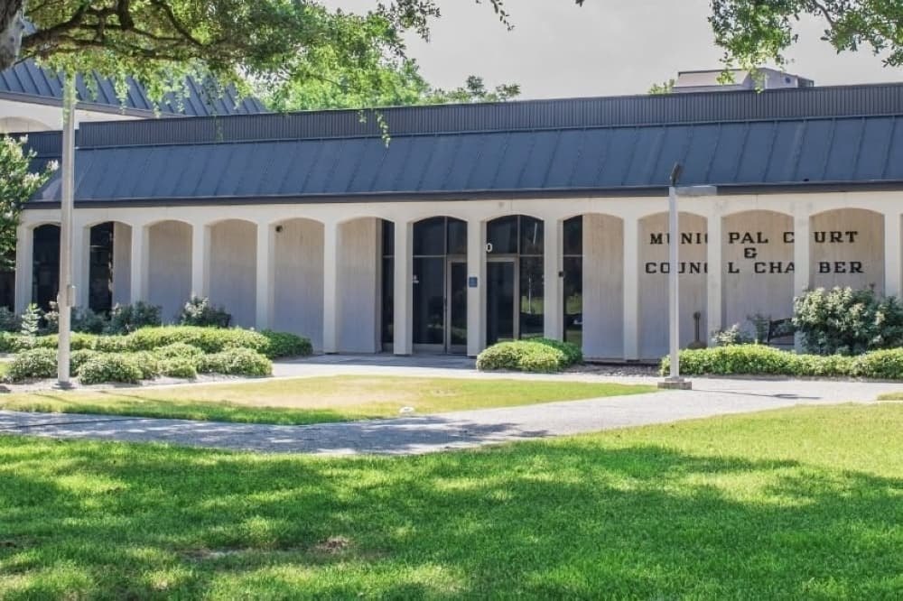 Single-story municipal building with arched colonnade labeled Municipal Court and Council Chamber.