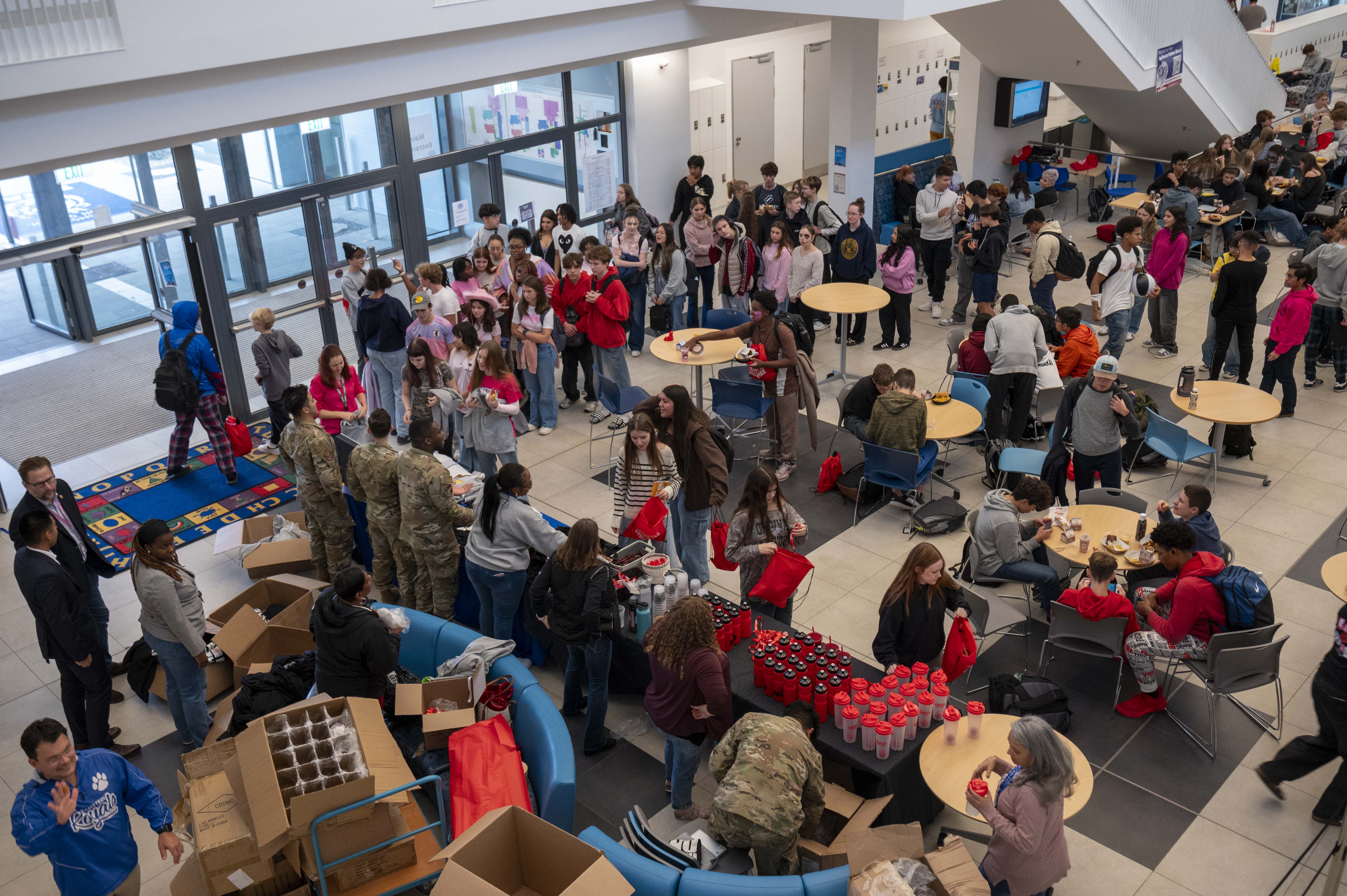 Students and adults fill a school lobby during a Red Ribbon Week gathering.