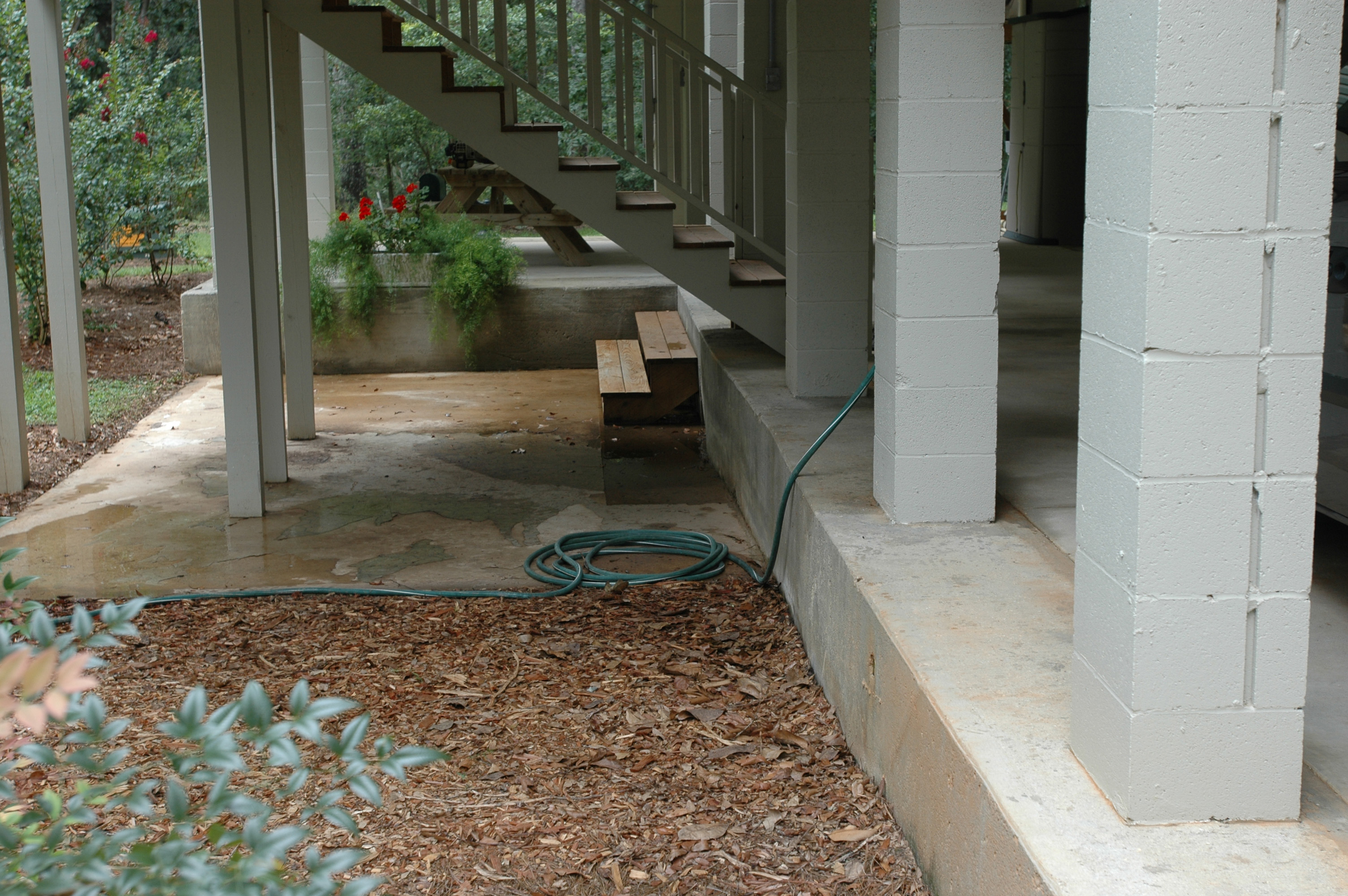 House raised on cinder block piers above a concrete slab to prevent flood damage.