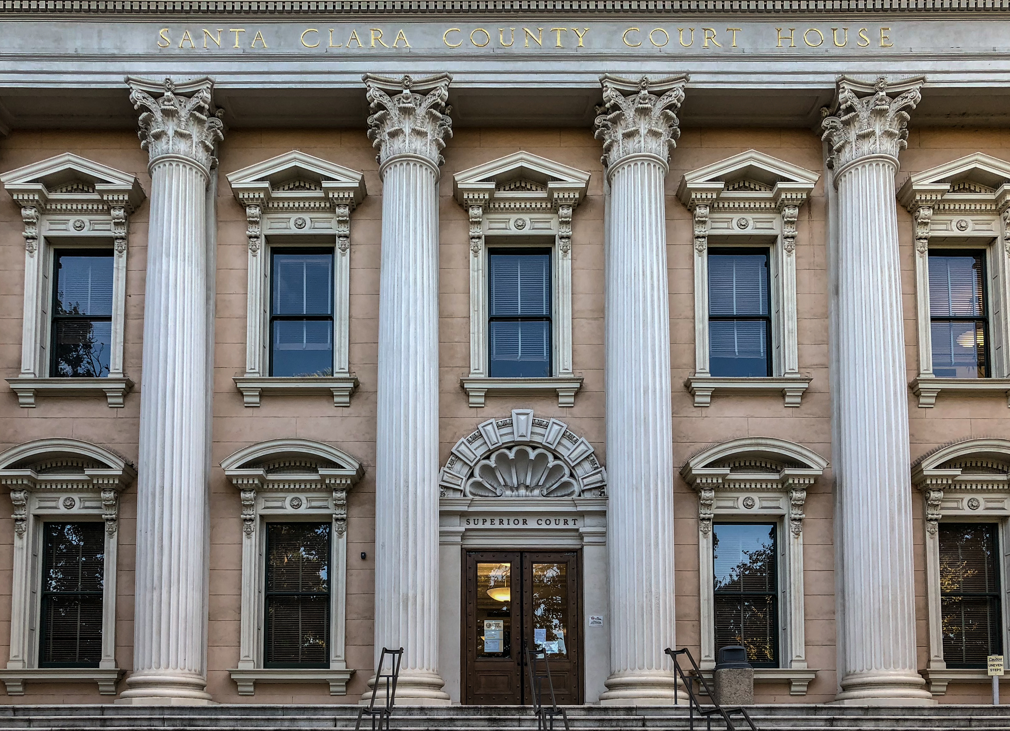 Neoclassical courthouse with tall white columns and 'Superior Court' carved above the entrance.