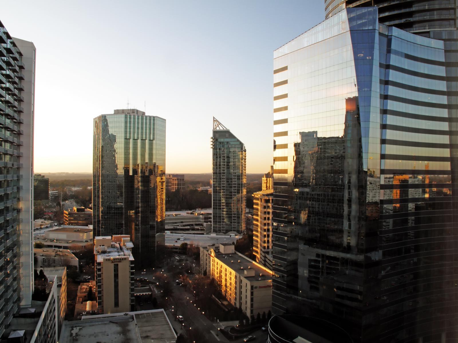 Glass-clad high-rise office towers photographed at golden hour from an elevated vantage point.
