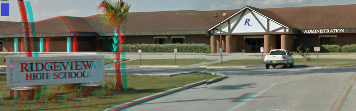 Exterior of a high school building with a sign reading Ridgeview High School in the foreground.